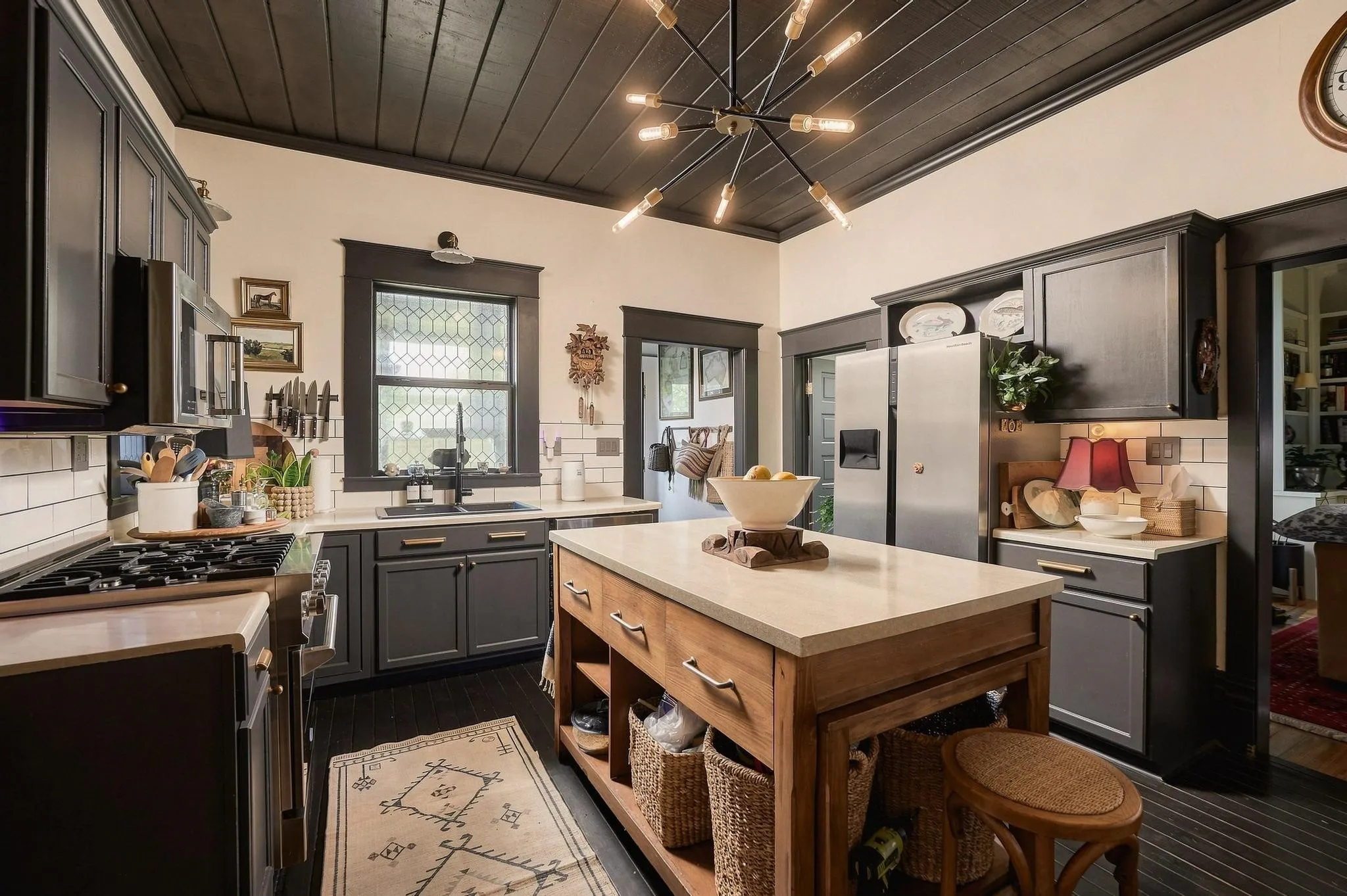 An eye-catching blend of contemporary statement lighting, stately door/window casings and a functional layout flowing to the laundry room.