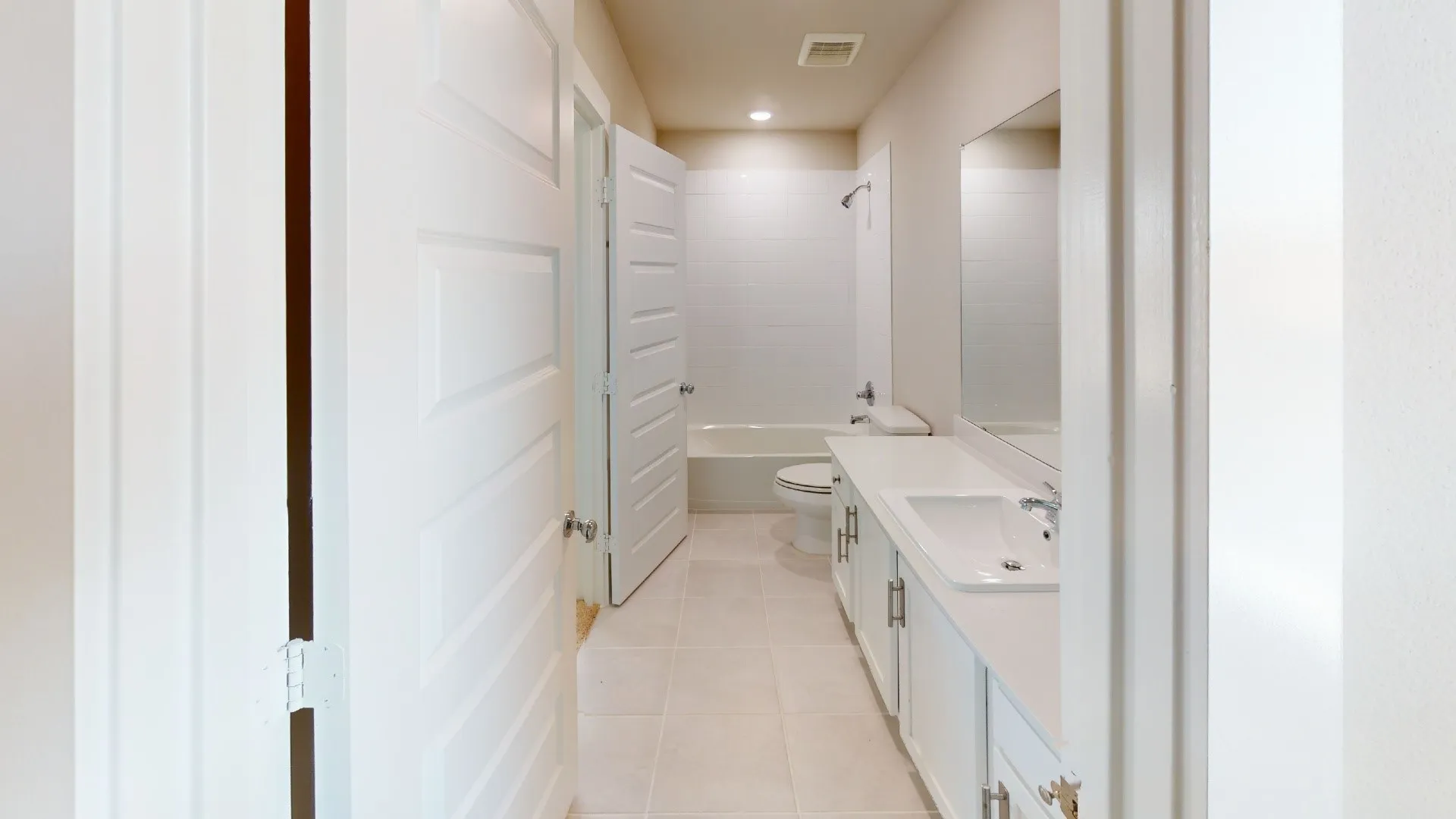 Bathroom featuring a single vanity, undermount sink, and a combination tub and shower