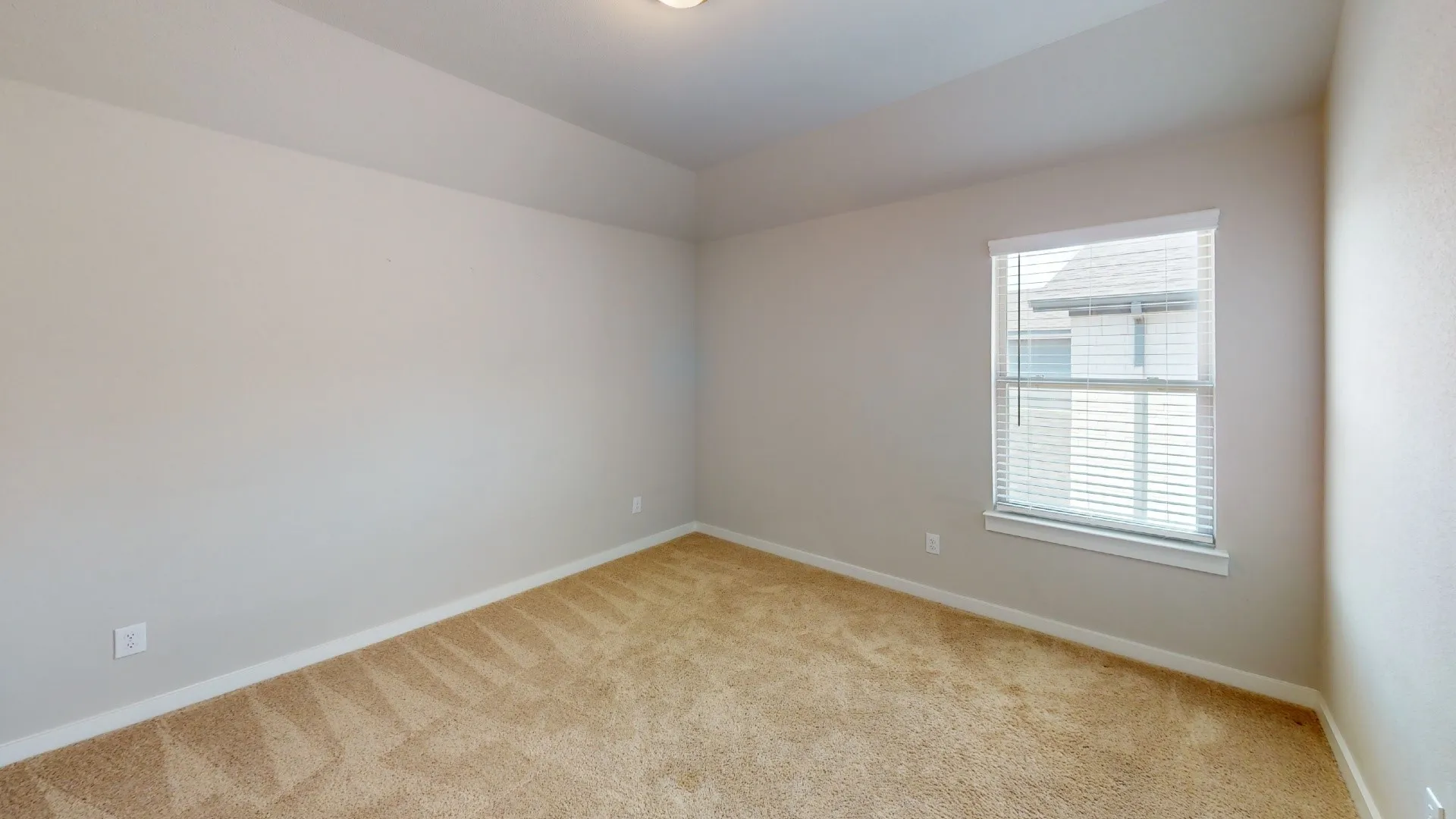 Recessed ceiling lighting, neutral-toned carpeting, single window with blinds, and light-colored walls