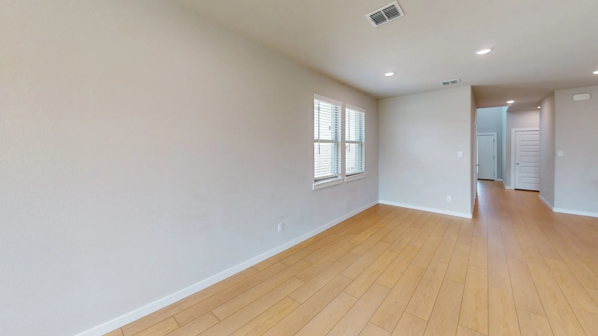 Light wood-finish flooring complemented by neutral wall tones