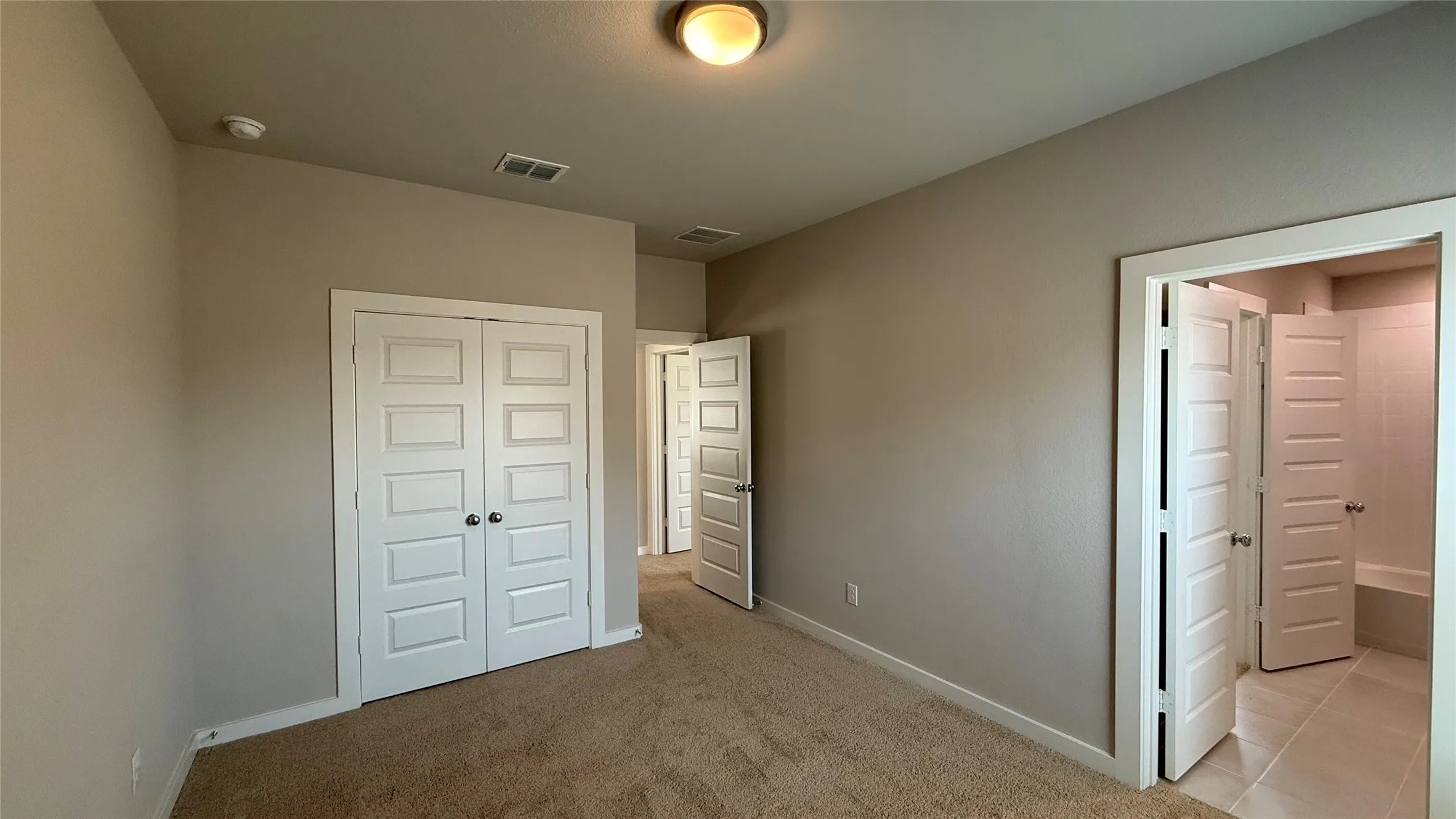 Neutral-toned walls complement carpeted flooring