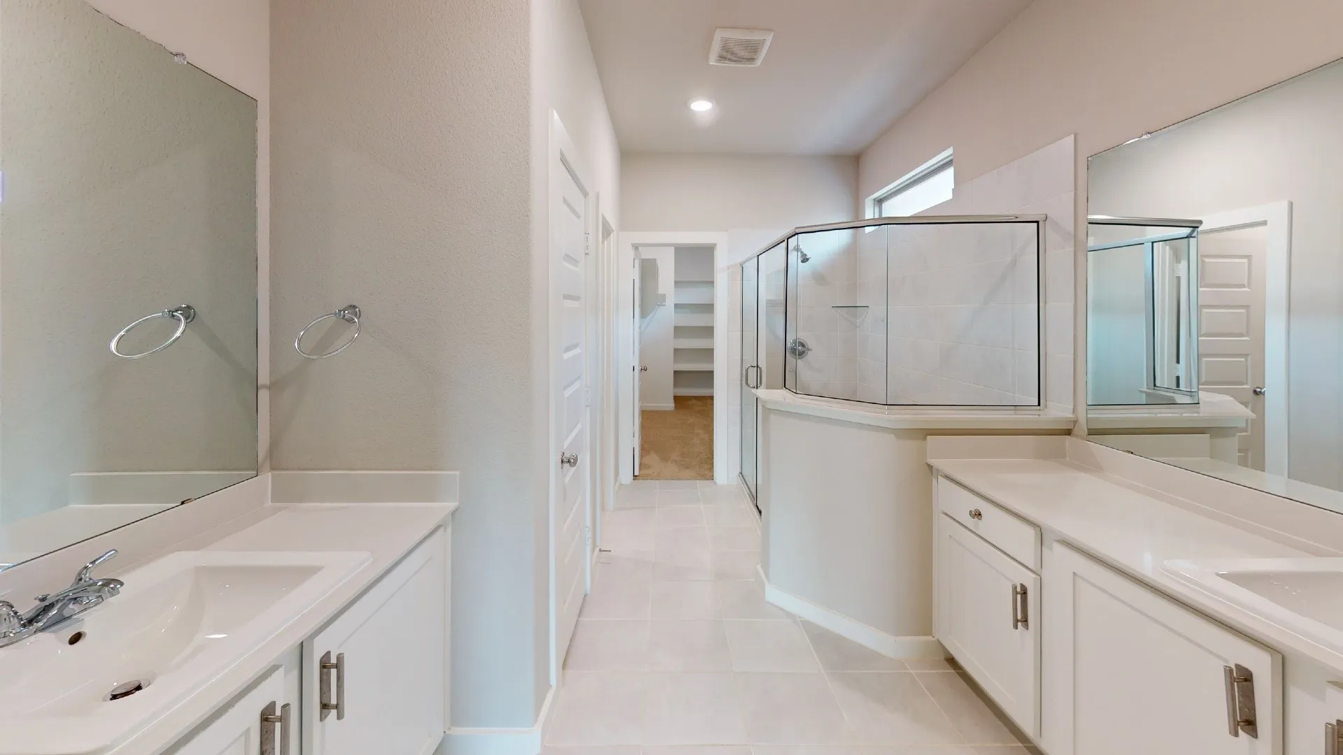 Dual vanity with white cabinetry and integrated sinks