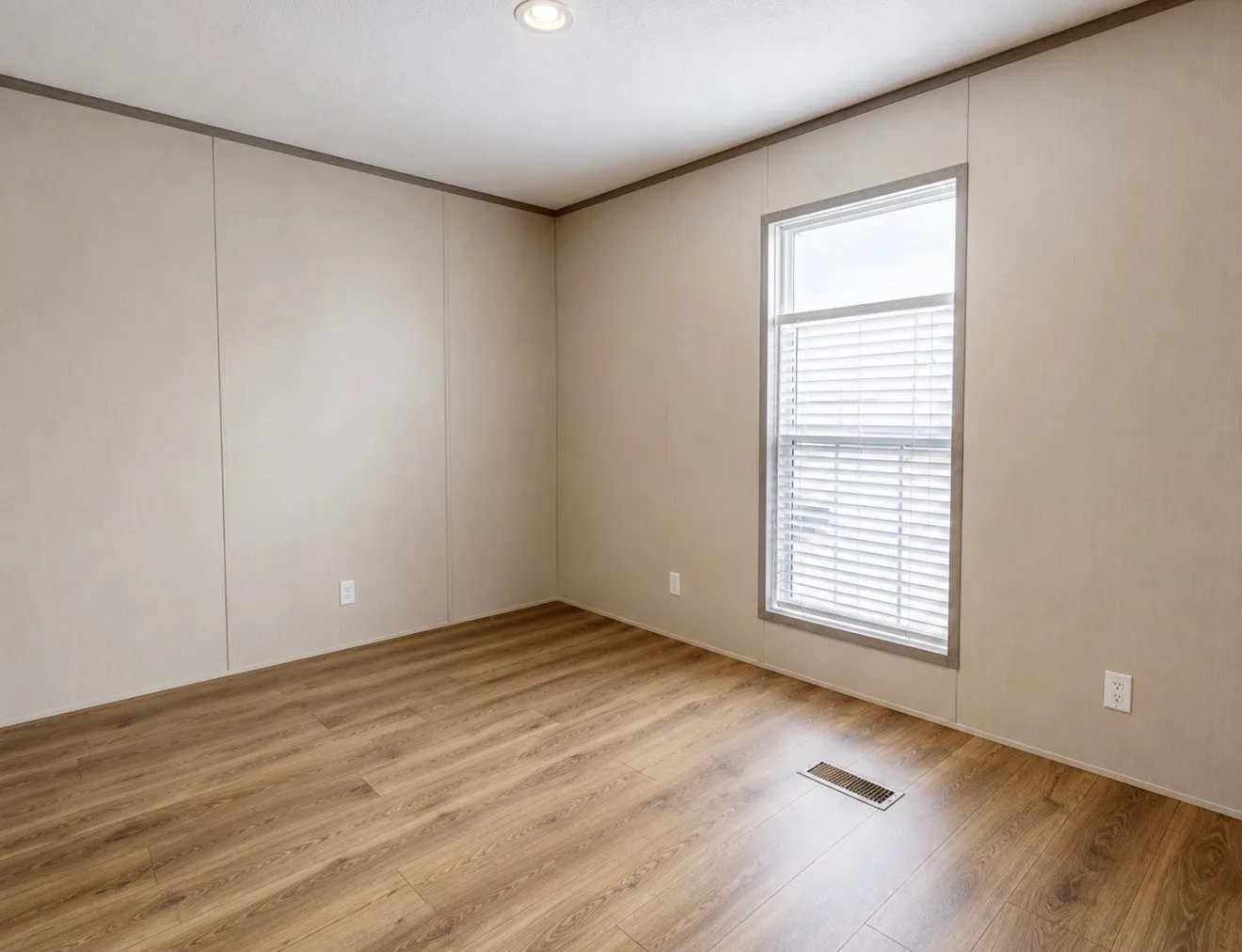Recessed ceiling lighting, wood-finish flooring, and a window with blinds