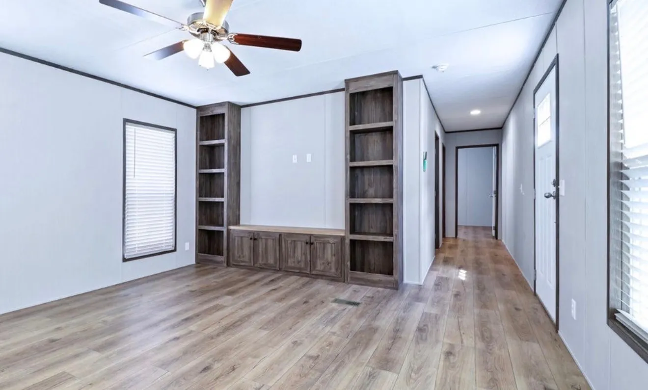 Wood-finish flooring, built-in shelving, integrated cabinetry, ceiling fan with light fixture, and window with blinds