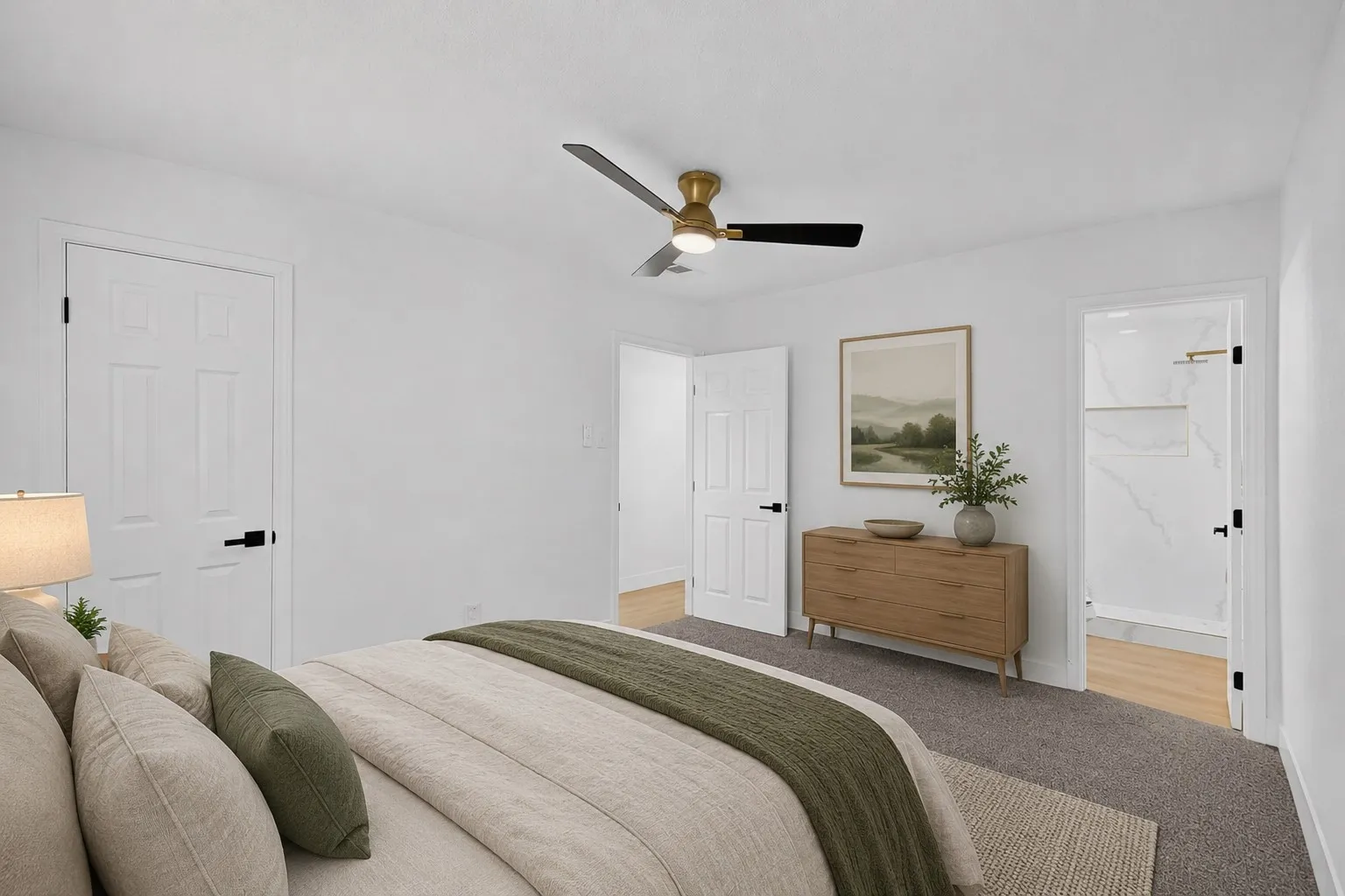 Virtually staged plush carpet flooring, brass and black ceiling fan, white paneled doors, black door hardware, and a fully tiled shower with a built-in shelf
