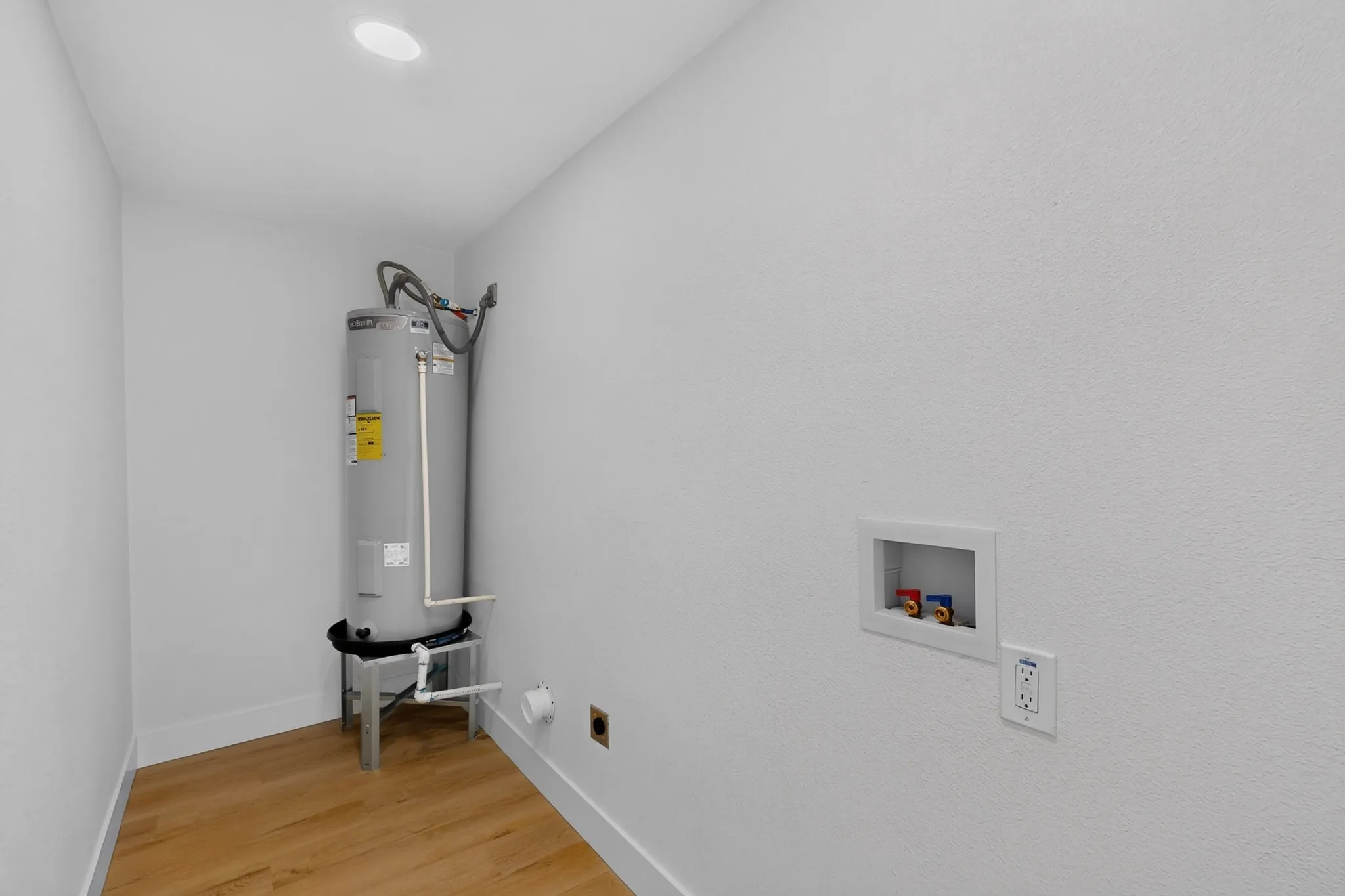 Recessed lighting, wood-finish flooring, and a water heater