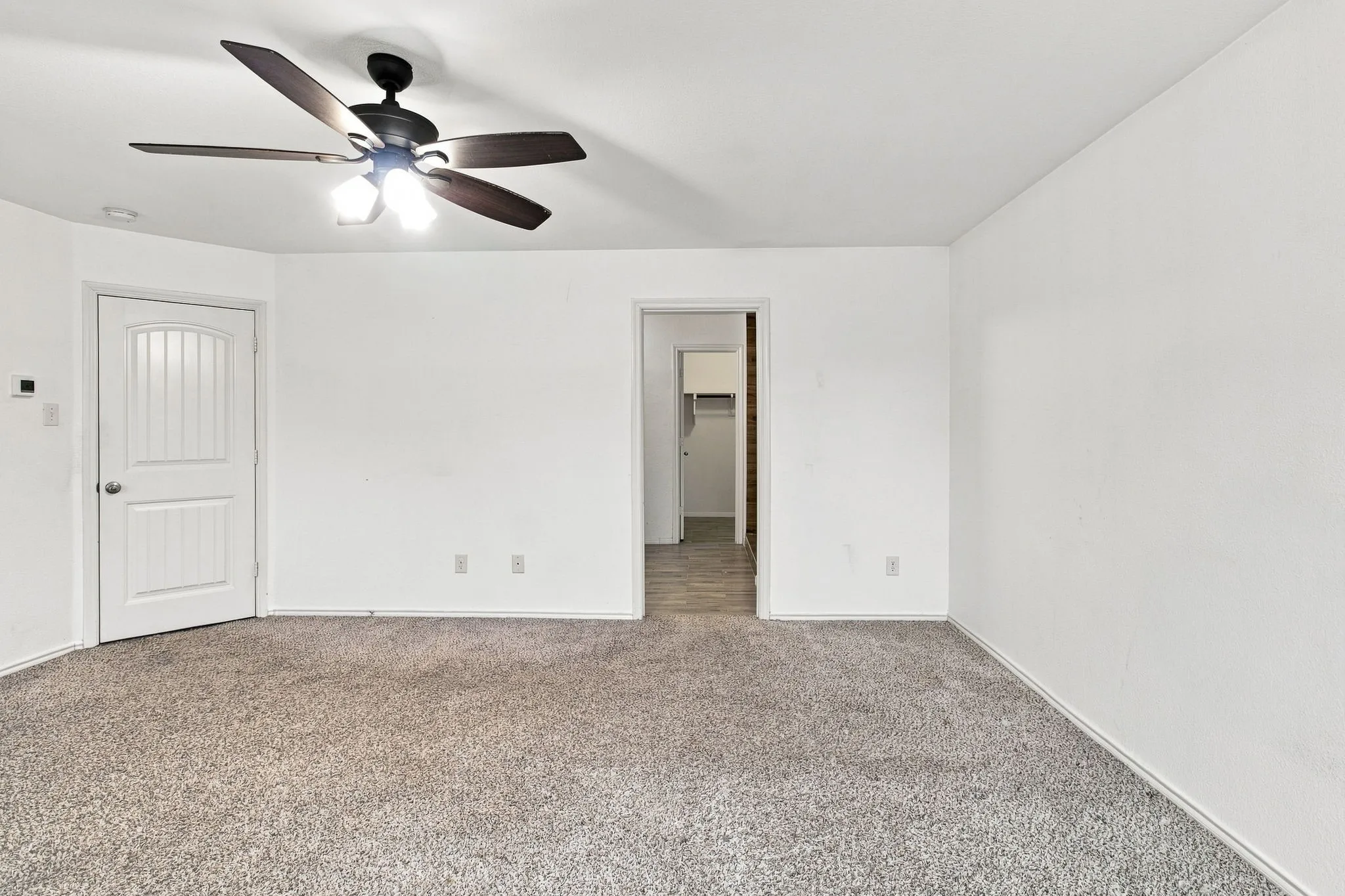 Recessed lighting, ceiling fan with integrated light fixture, light gray carpet, white walls, and white trim