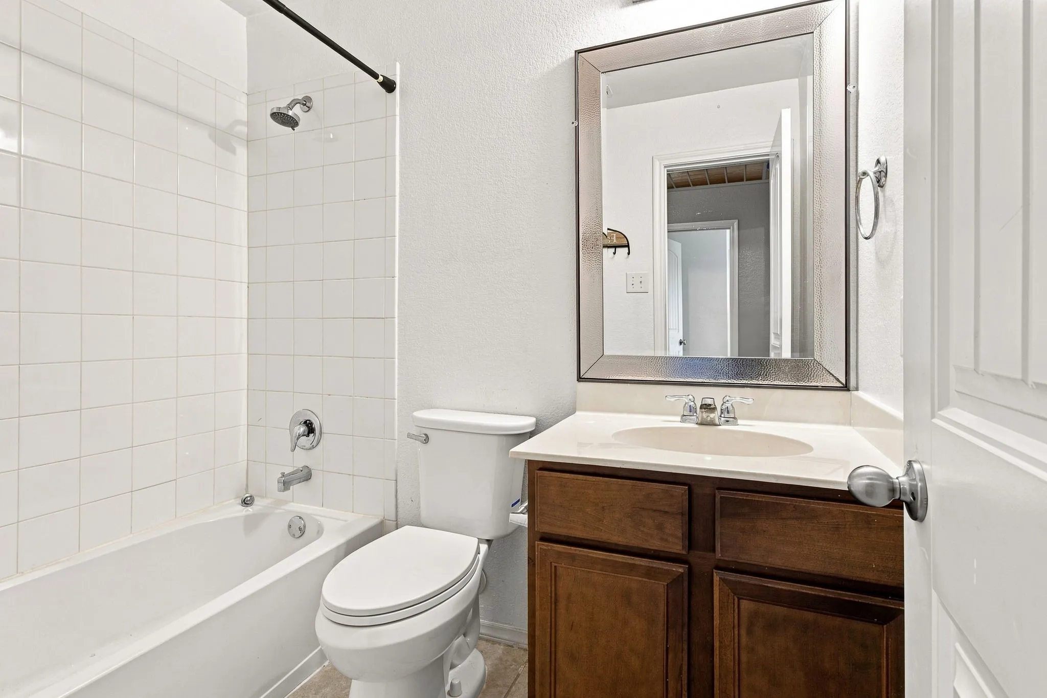 Bathroom featuring a vanity with dark wood-finish cabinetry, a white countertop, and an integrated sink