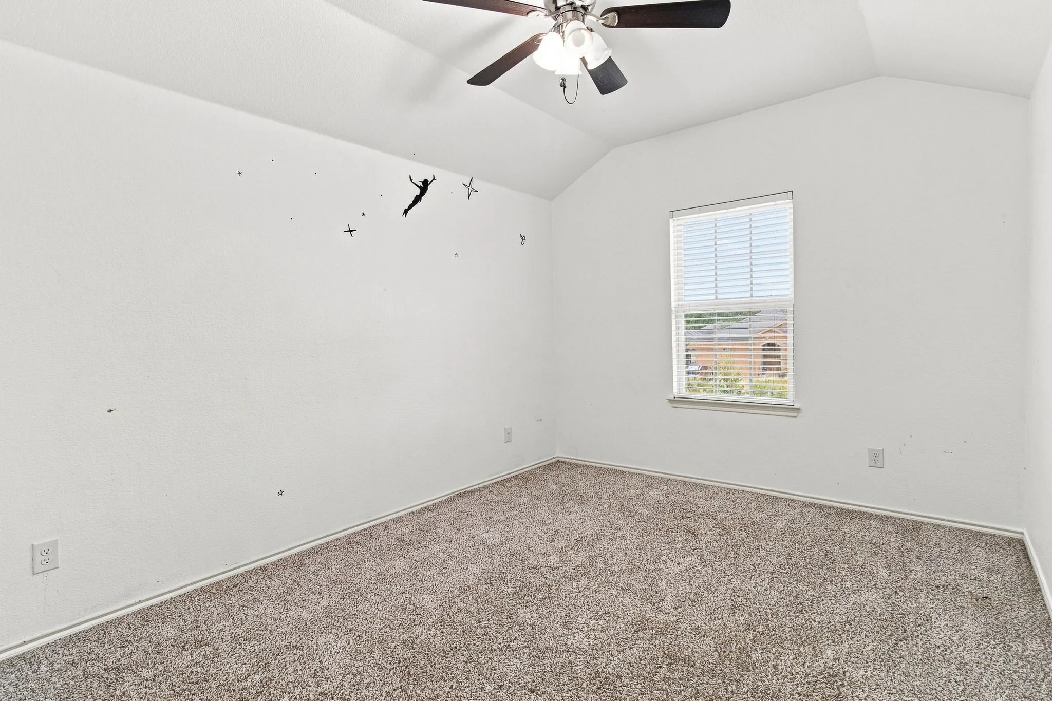 Vaulted ceiling with a ceiling fan, carpeted flooring, and a window with blinds