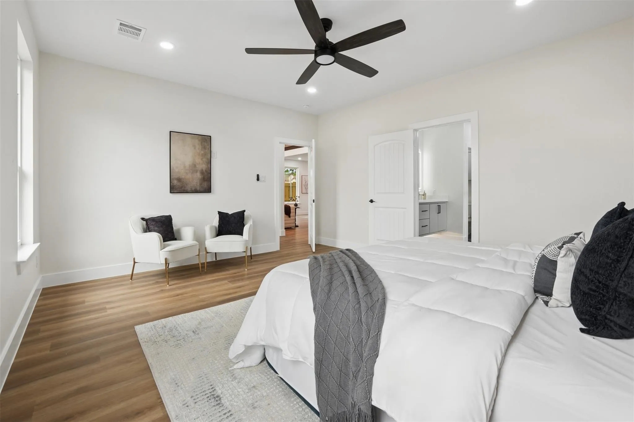 Recessed lighting, wood-finish flooring, and a ceiling fan