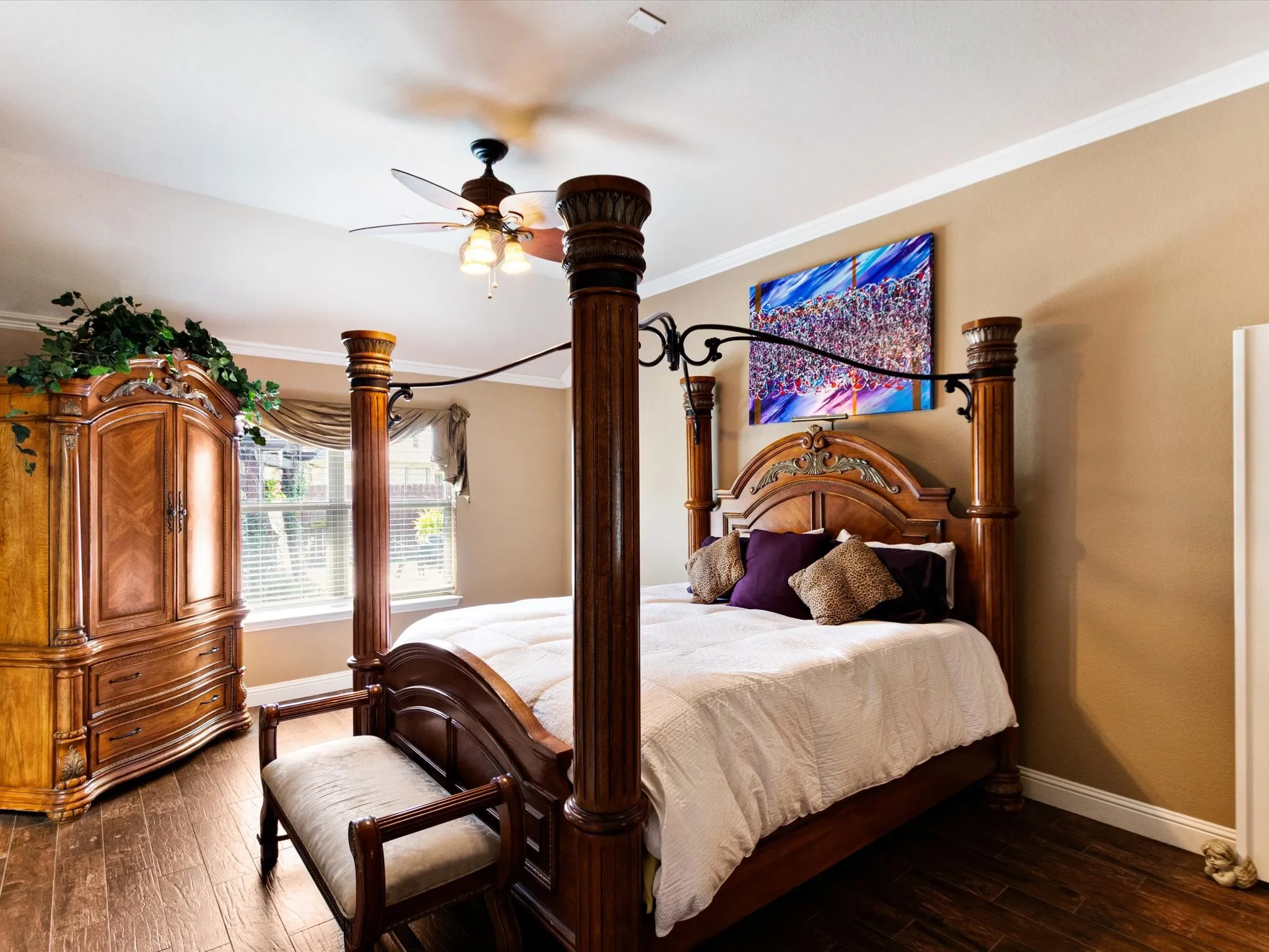 Wood-finish flooring, crown molding, ceiling fan with light fixture, window with blinds, and neutral wall paint