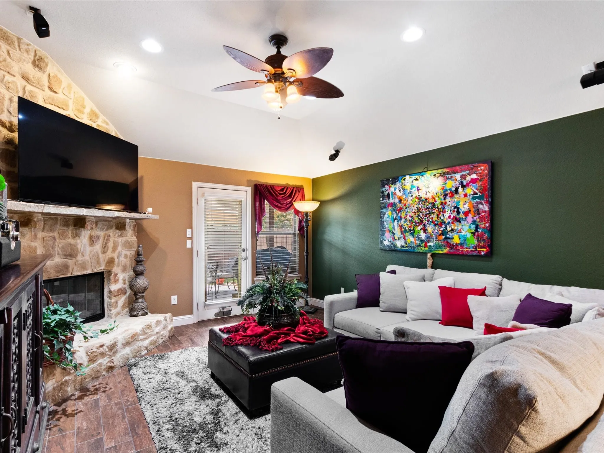 Vaulted ceiling with recessed lighting and a ceiling fan