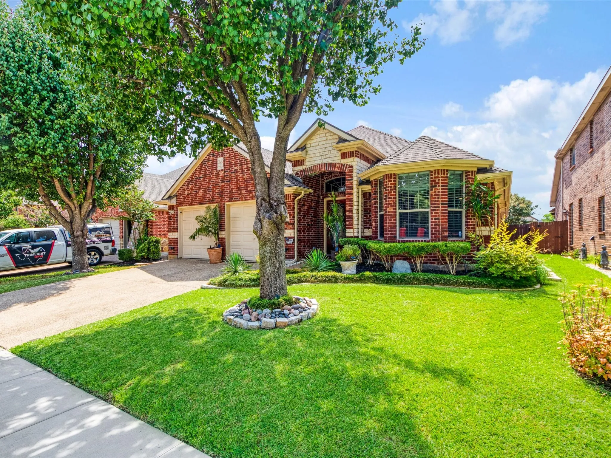 Brick exterior with a stone accent facade and a two-car garage