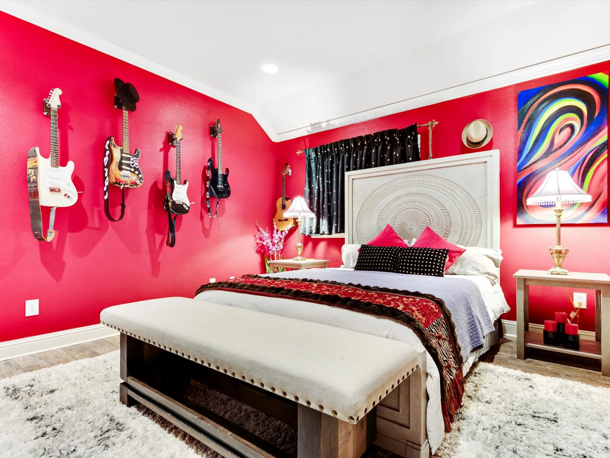 Tray ceiling, wood-finish flooring, recessed lighting, window with dark-colored drapery, built-in wall sconces