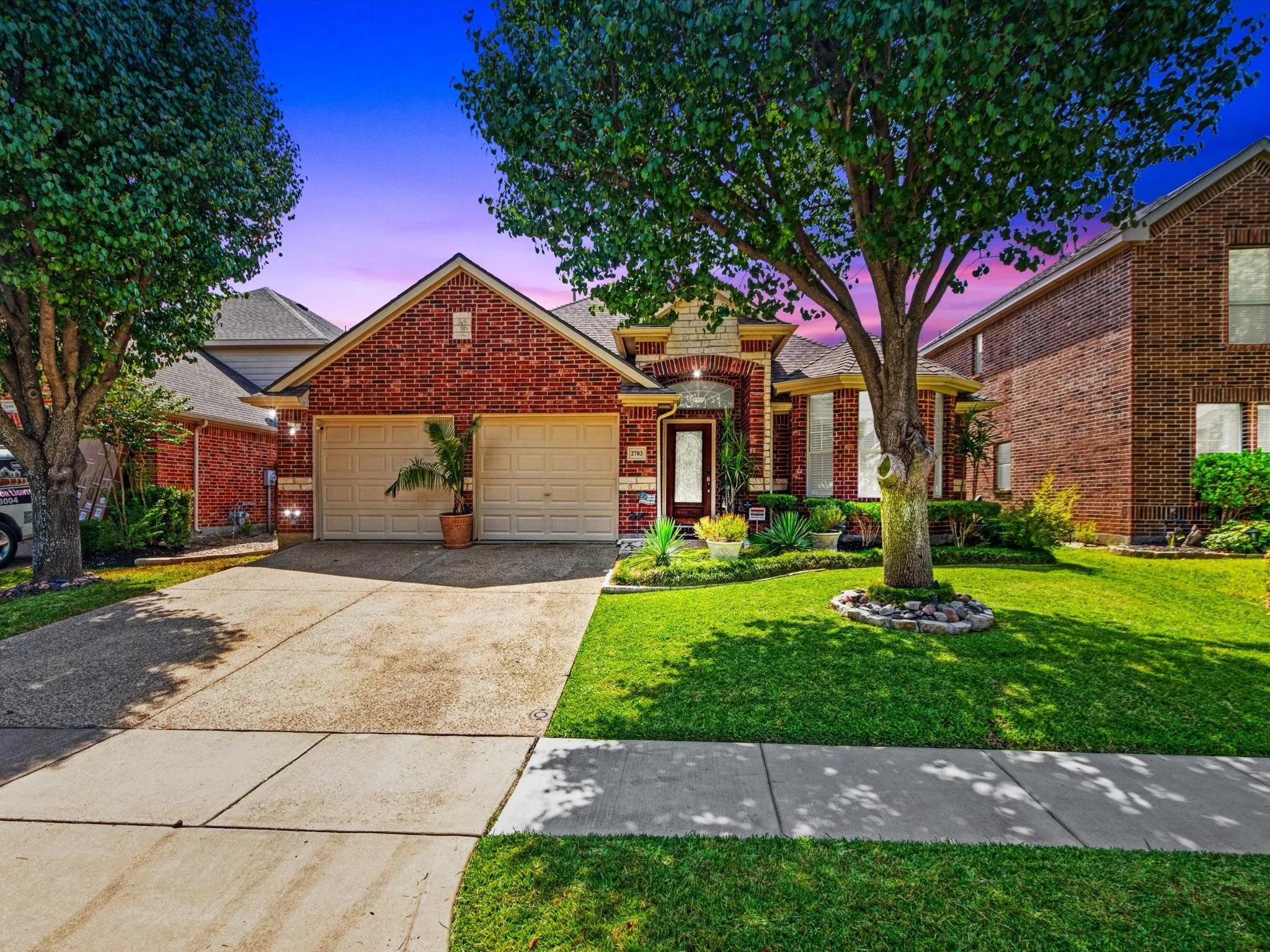Brick exterior with stone accents and a covered entry
