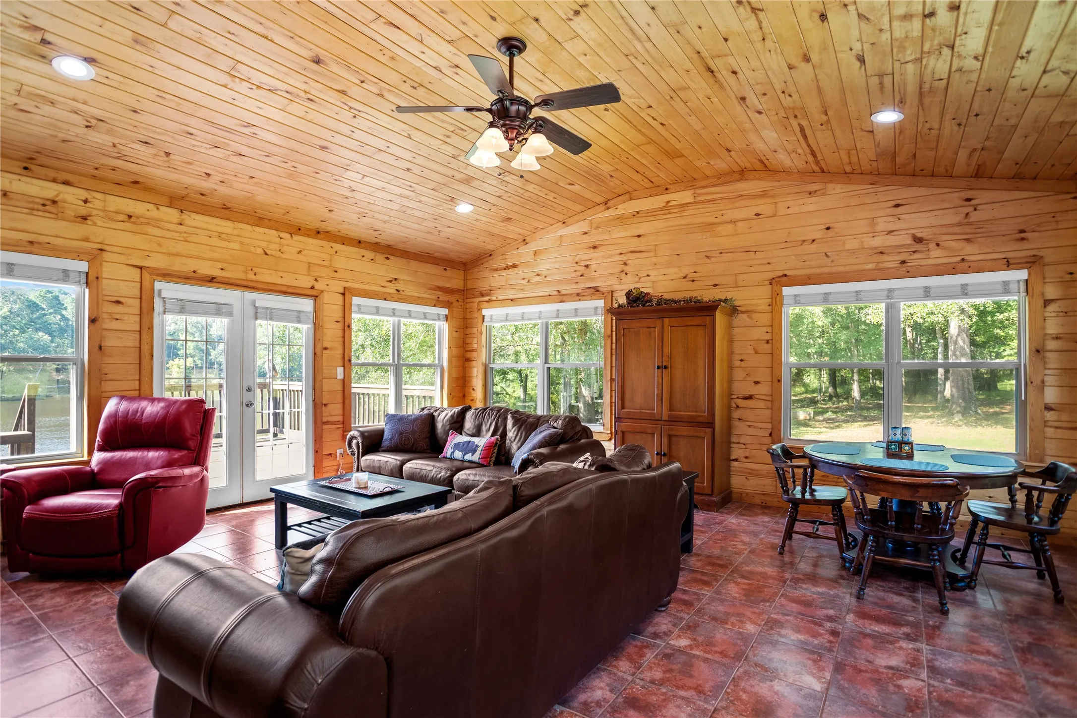 Family room area with vaulted ceiling, recessed lighting, french doors, aspen wood walls and ceiling