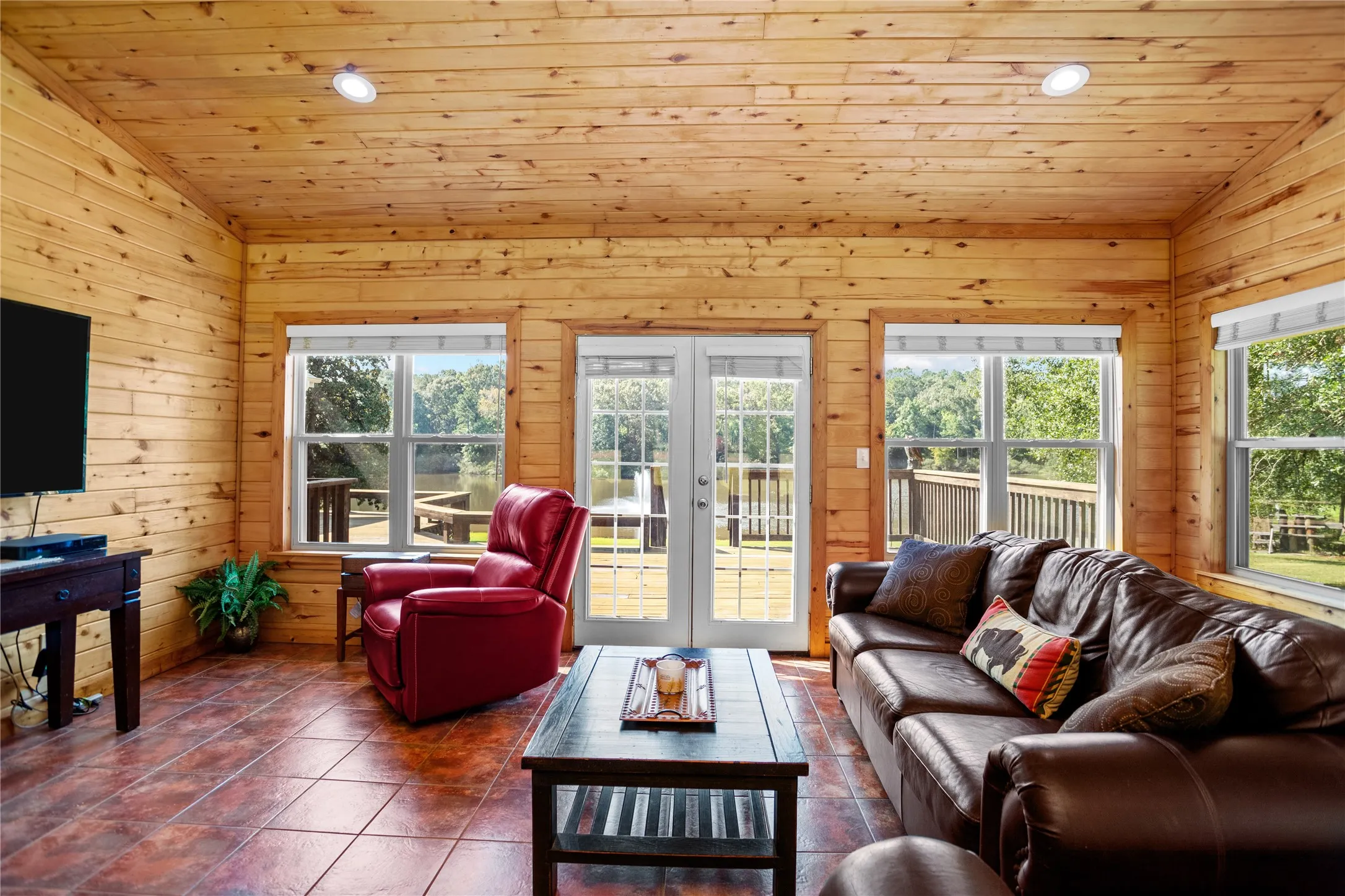 Family room area with vaulted ceiling, aspen wood walls, tile flooring, recessed lighting, and aspen wood ceiling