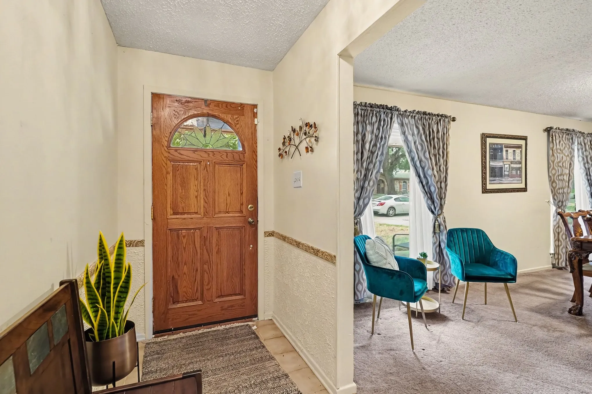 Paneled wood entry door with an arched decorative glass insert