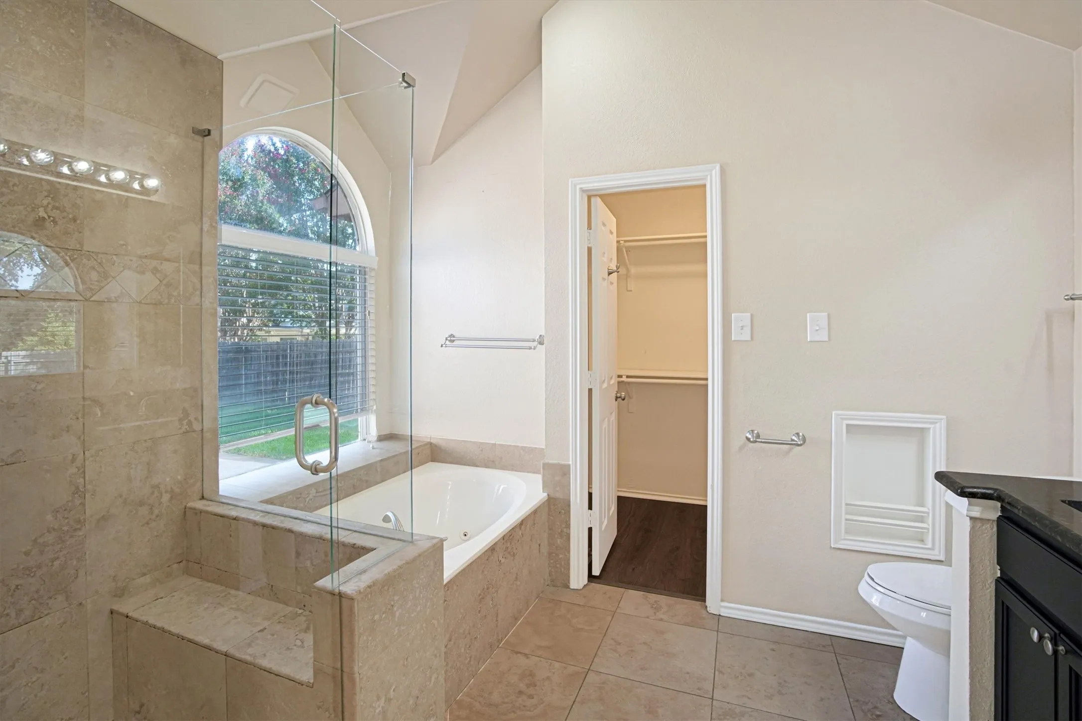 Ensuite primary bathroom with separate tub and shower