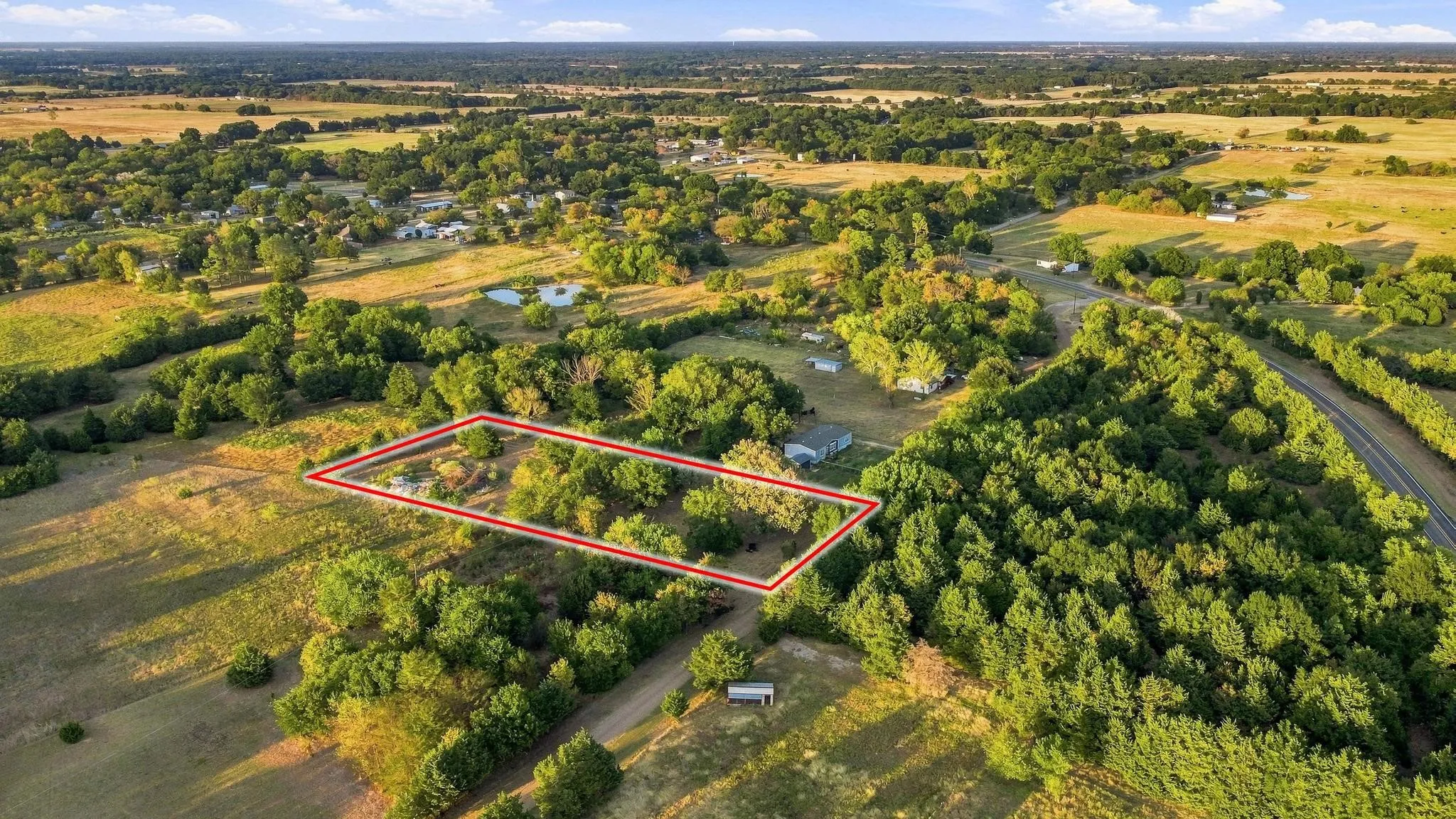 Expansive acreage featuring mature trees and open fields