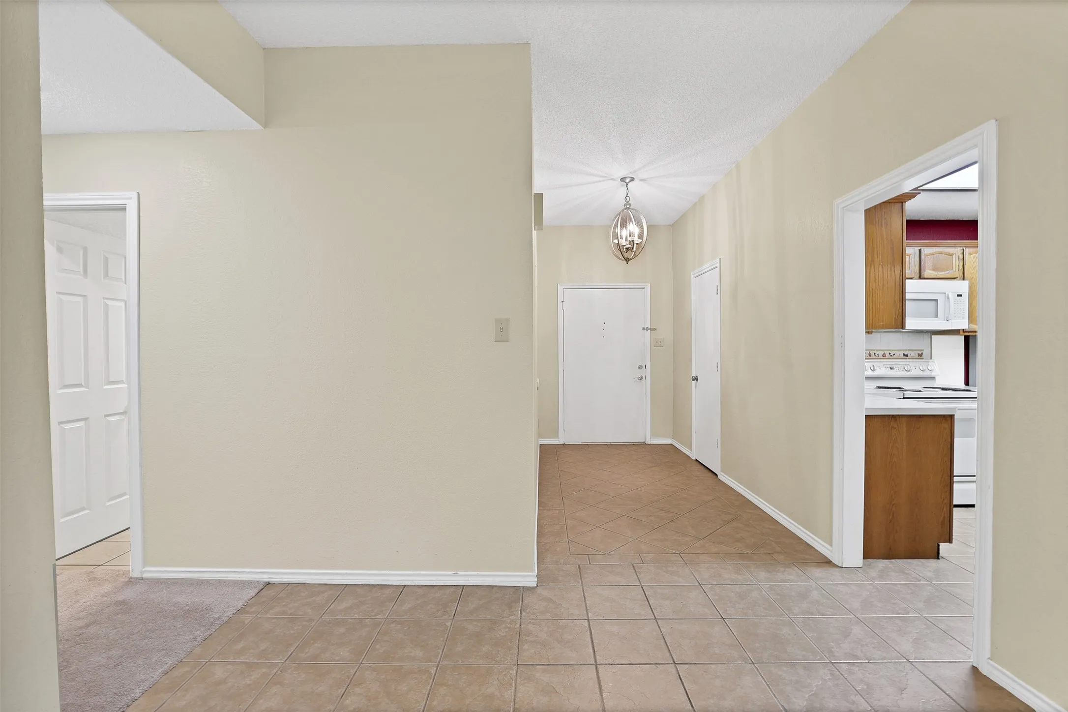Hallway that leads to bathroom and bedrooms