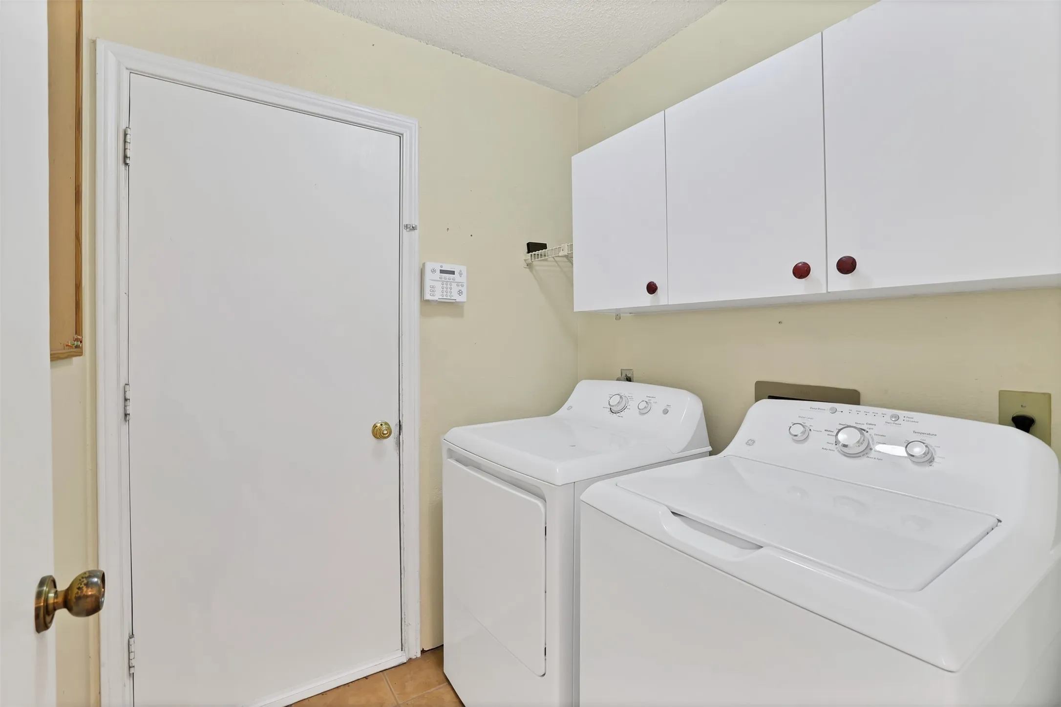 full size washer and dryer with cabinets.