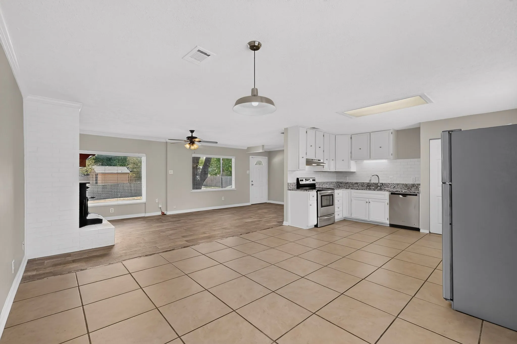 Bright dining area showcasing tile floors, ready for new furnishings.