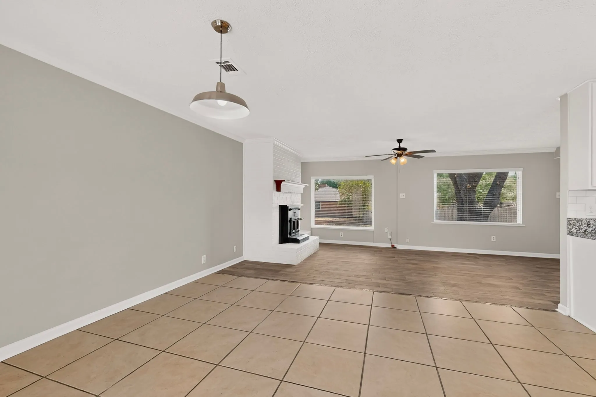 Open dining area with clean tile flooring, perfect for a fresh design.