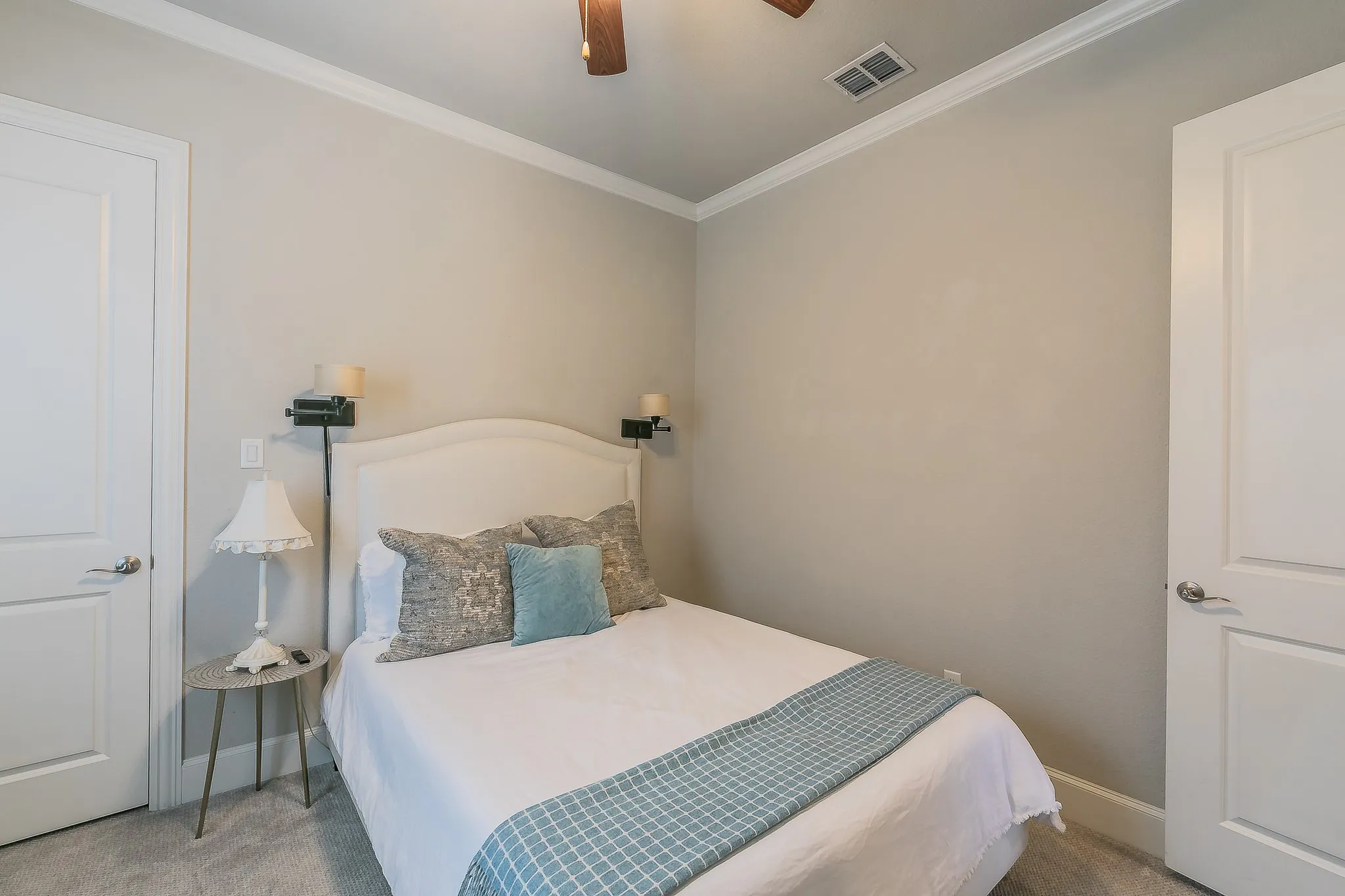 Crown molding, recessed lighting, ceiling fan, neutral wall color, and carpeted flooring