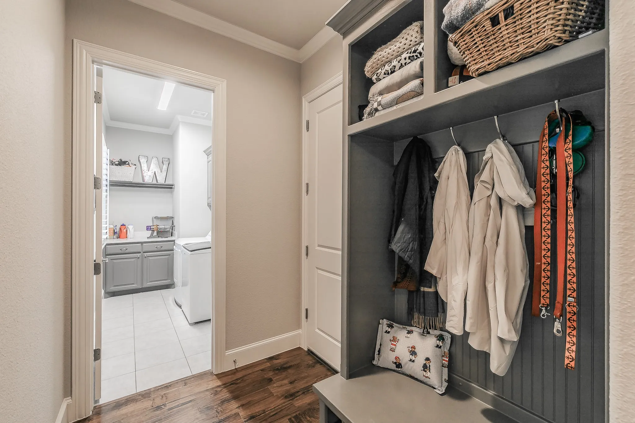 Built-in cabinetry with beadboard paneling and integrated shelving