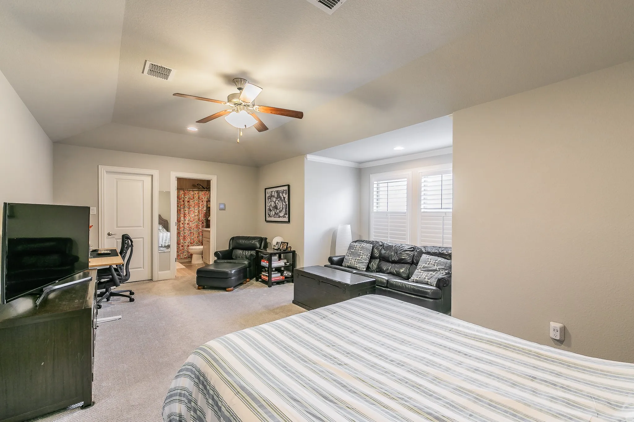 Carpeted interior with a ceiling fan, recessed lighting, and white plantation shutters