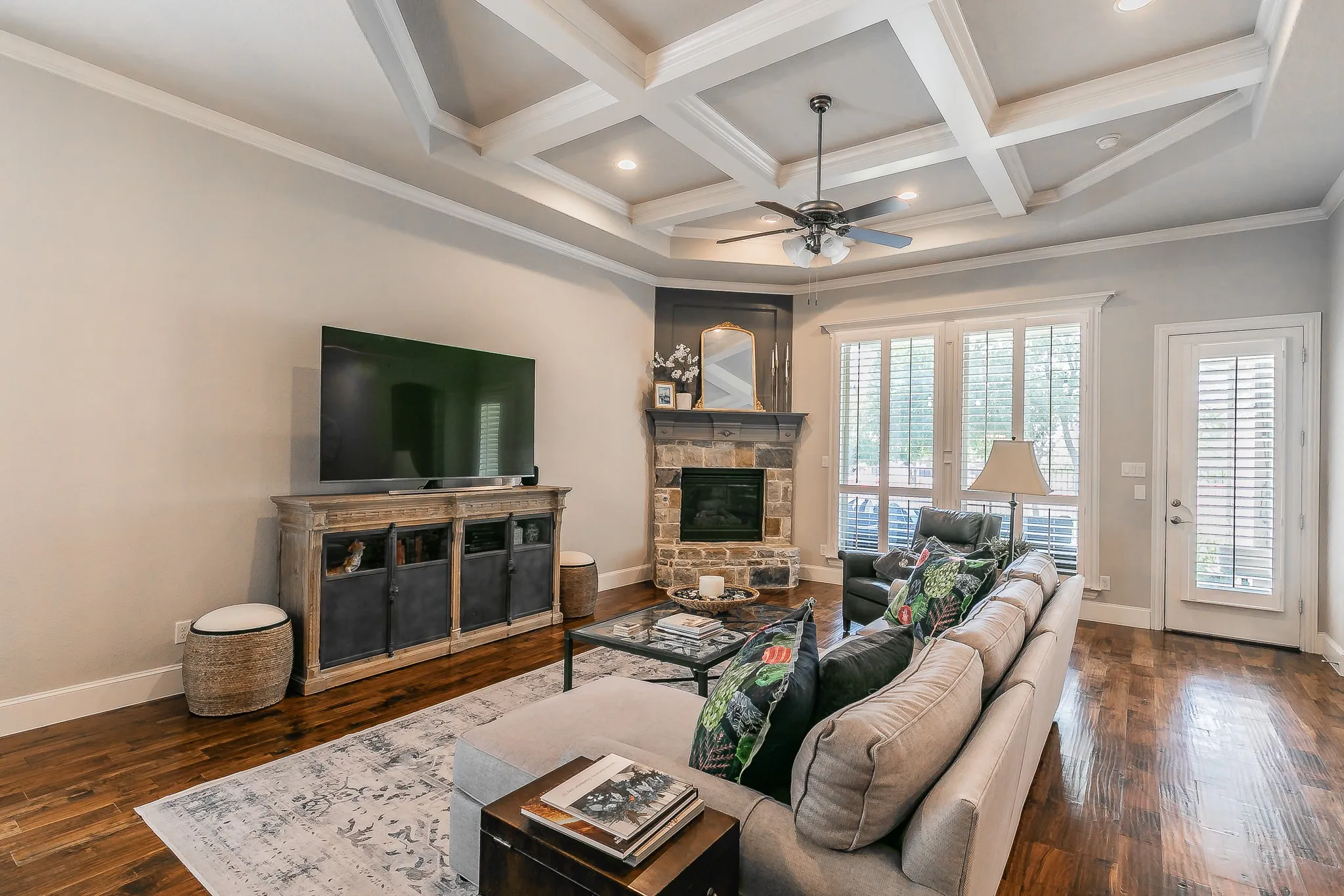 Coffered ceiling with recessed lighting and a ceiling fan