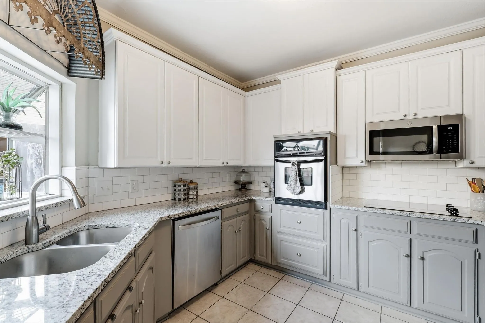 Updates include painted cabinets, quartz countertops, new appliances, subway tile backsplash