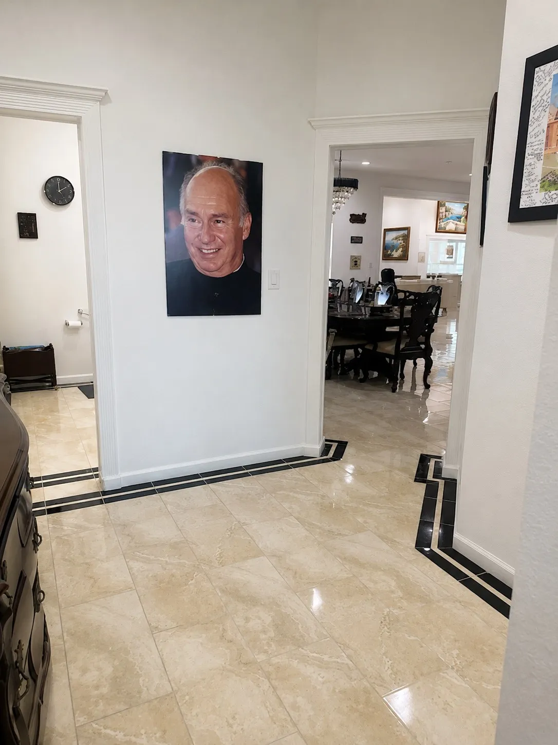 Neutral-toned tile flooring with a black tile border detail