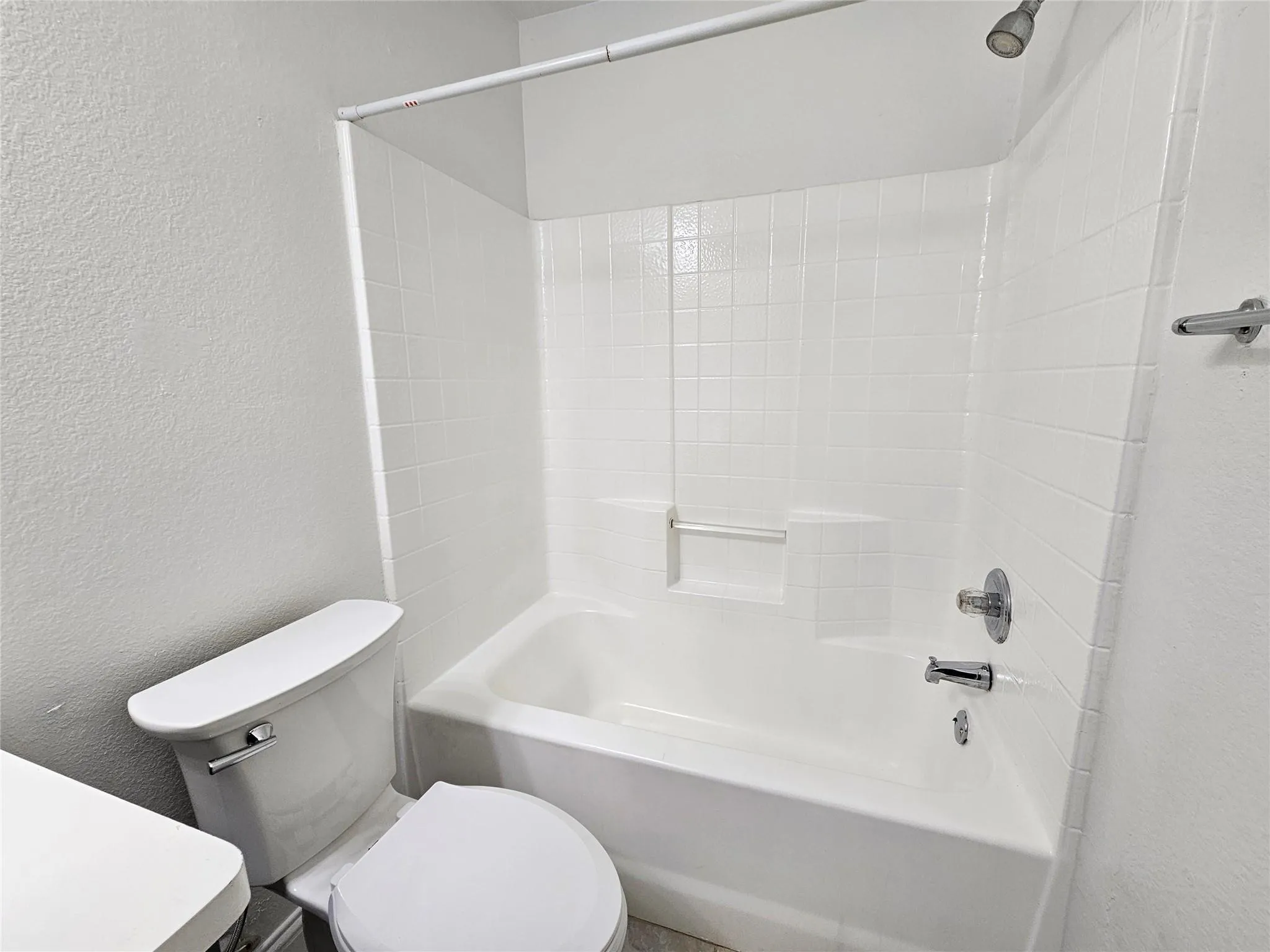 Tub/shower combination with white subway tile surround and chrome fixtures