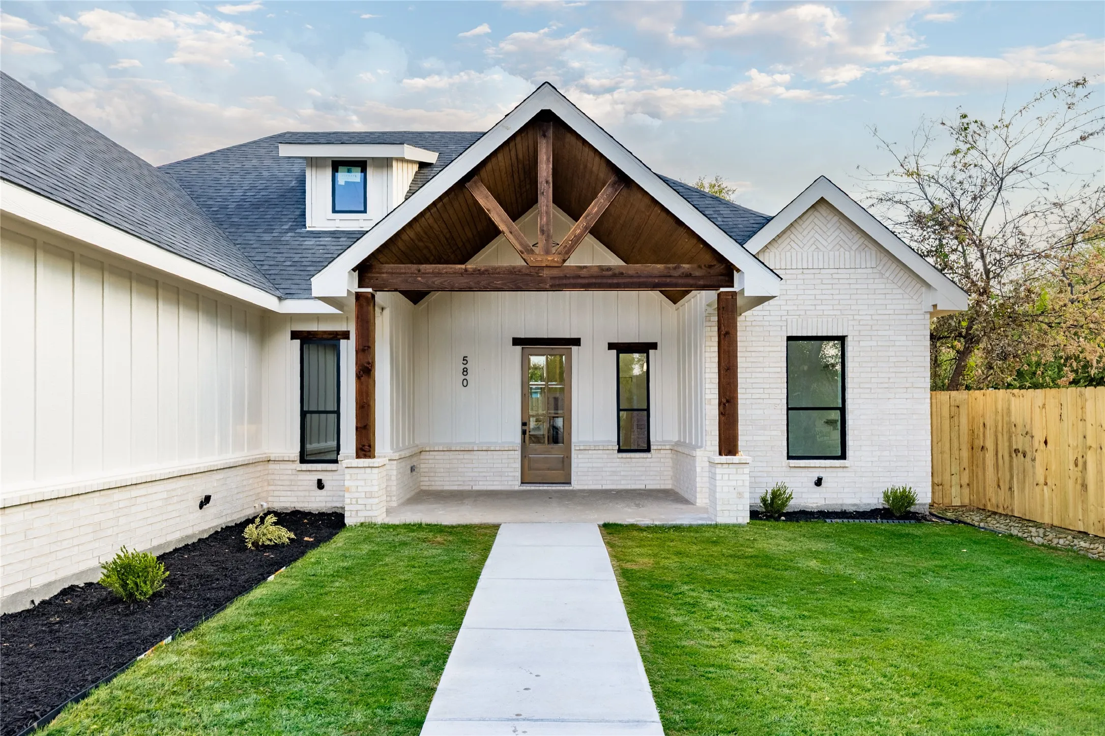 Contemporary exterior featuring white brick and vertical siding