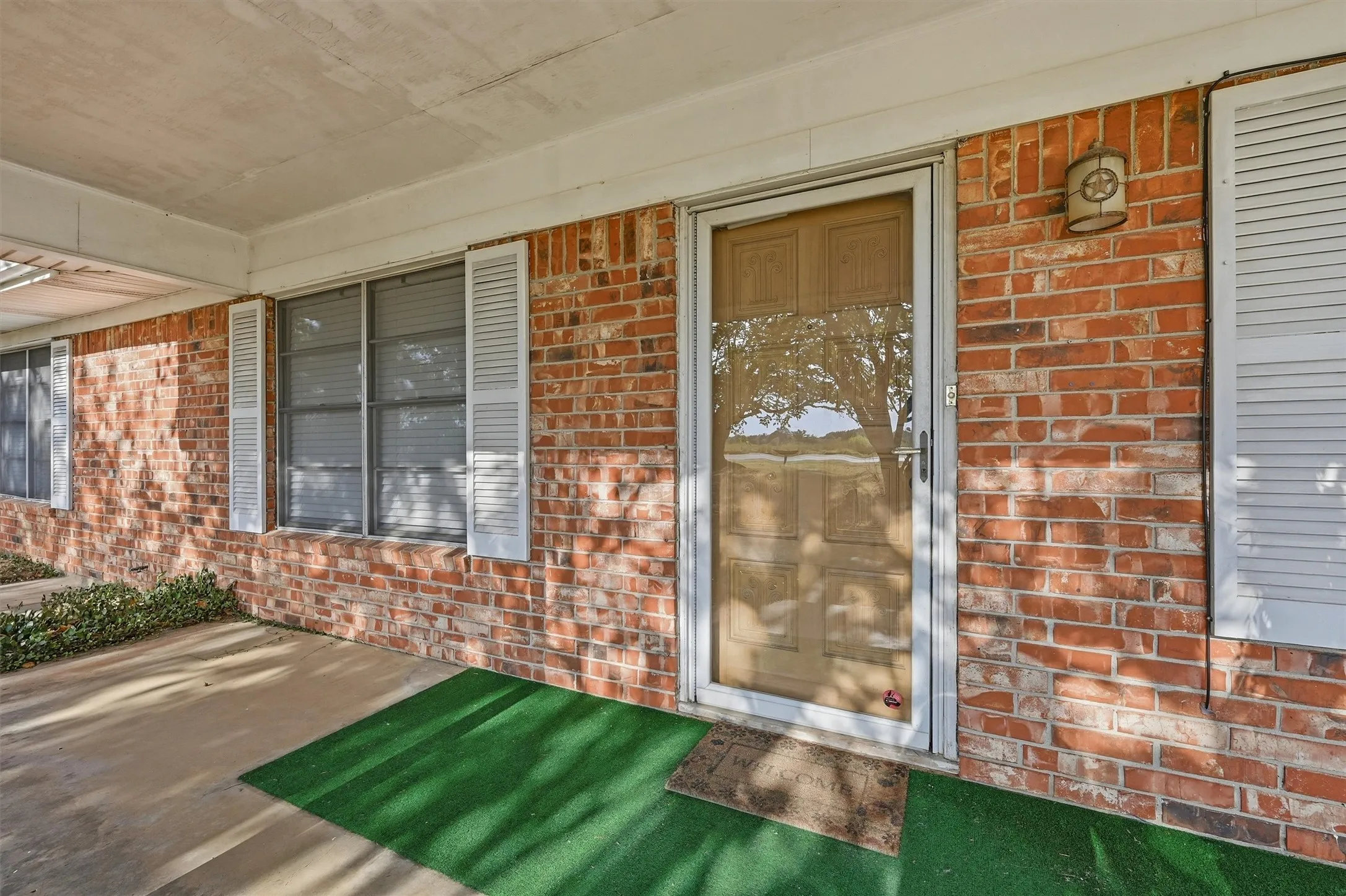 Brick exterior with a covered porch