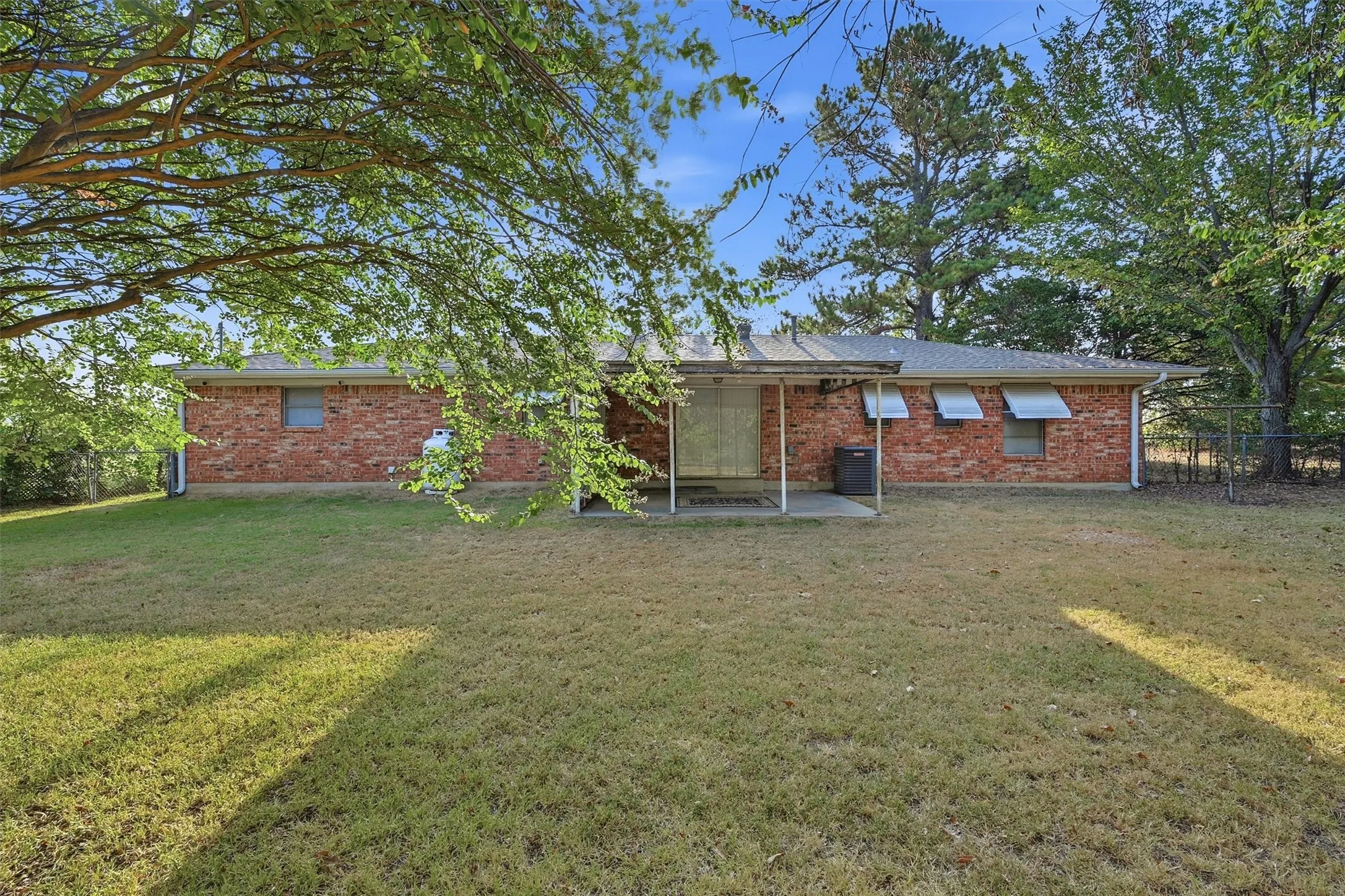 Brick ranch home situated on expansive grounds with mature shade trees