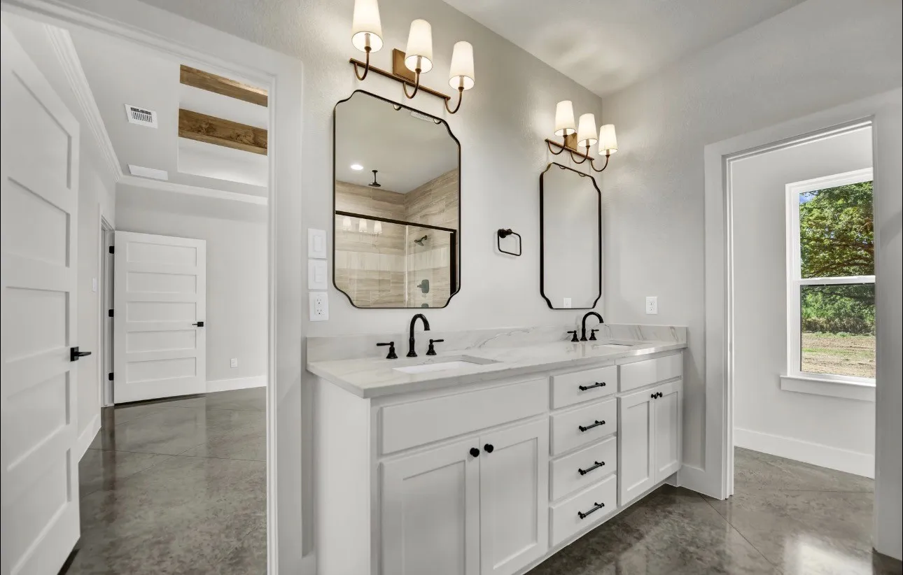 Dual vanity with undermount sinks, quartz countertops, and matte black fixtures