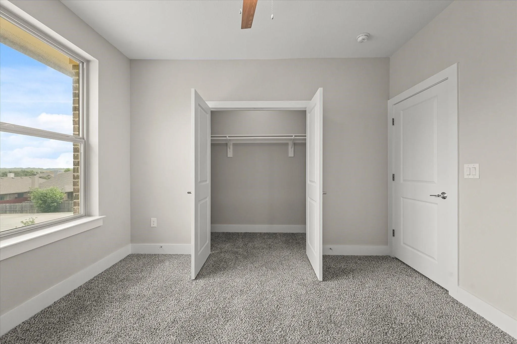 Neutral-toned walls with grey carpeting