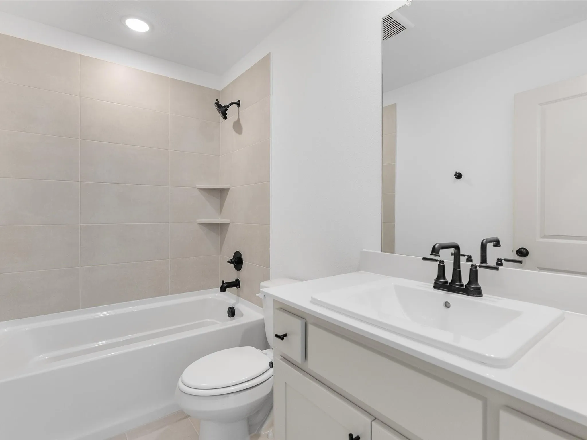 Ensuite Bath - Bedroom 1 - White vanity with a rectangular undermount sink, matte black faucet, and white countertop