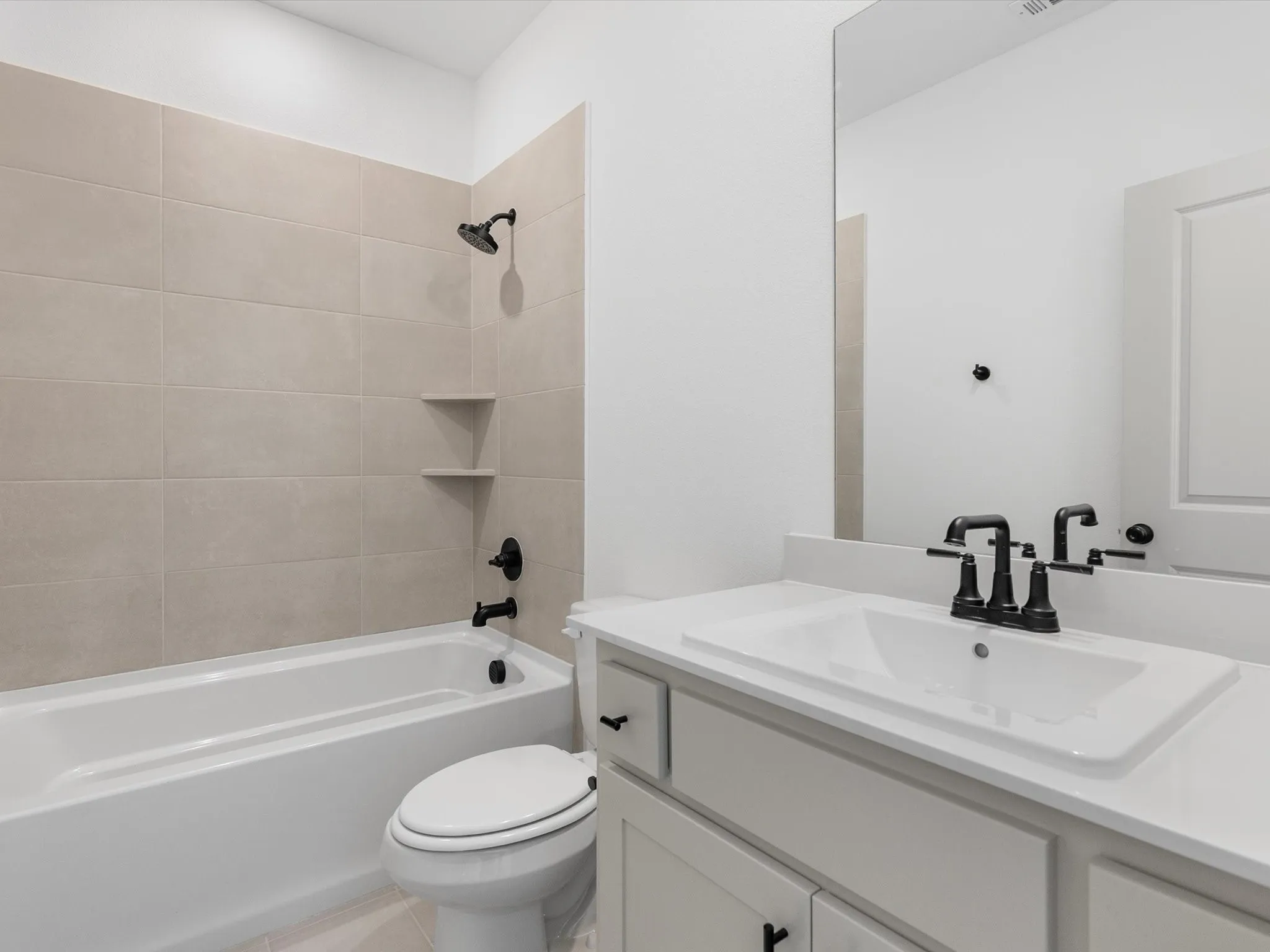 White vanity with an integrated sink and matte black faucet
