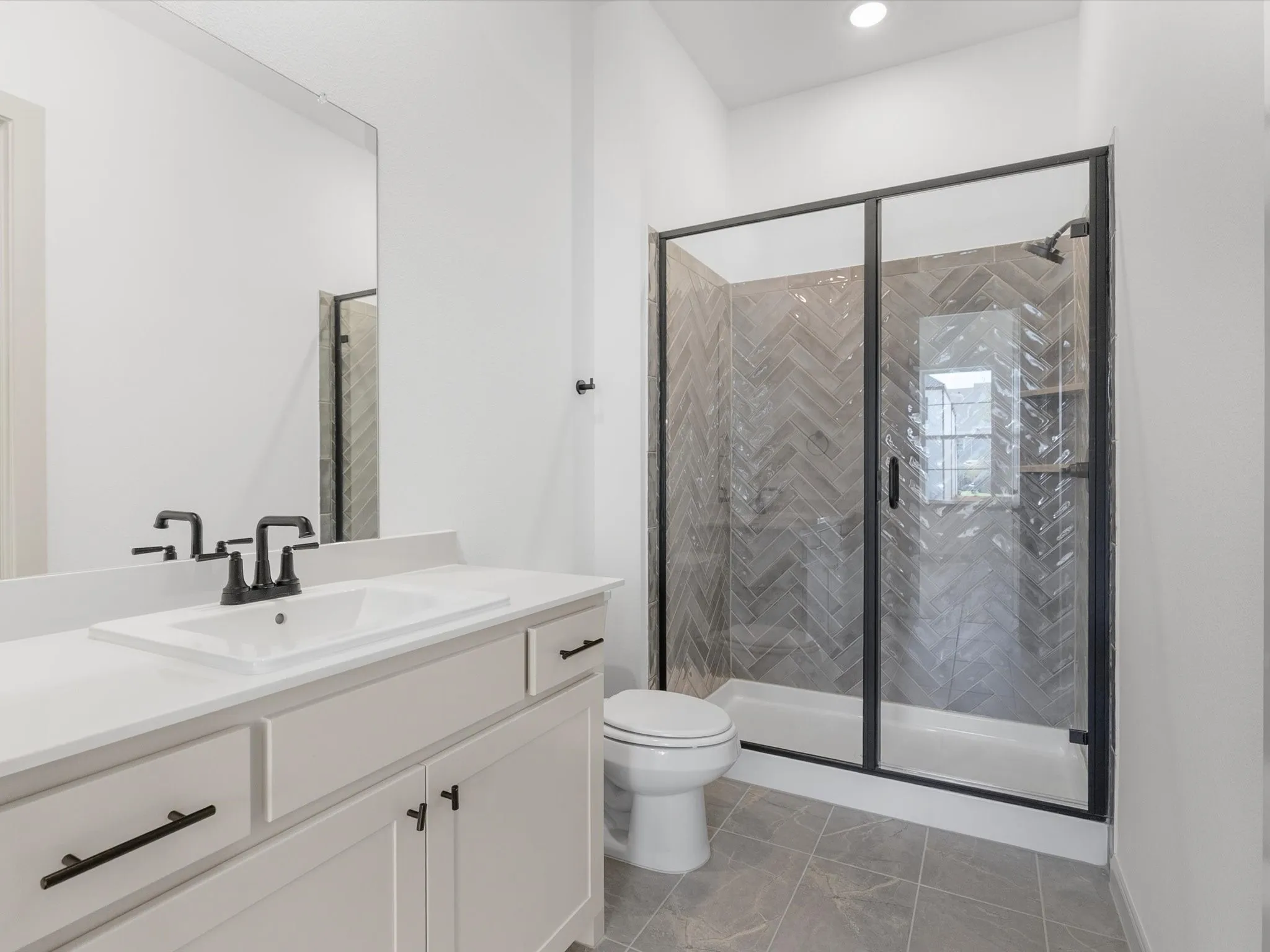 Vanity with an integrated sink, matte black faucet, and white countertop