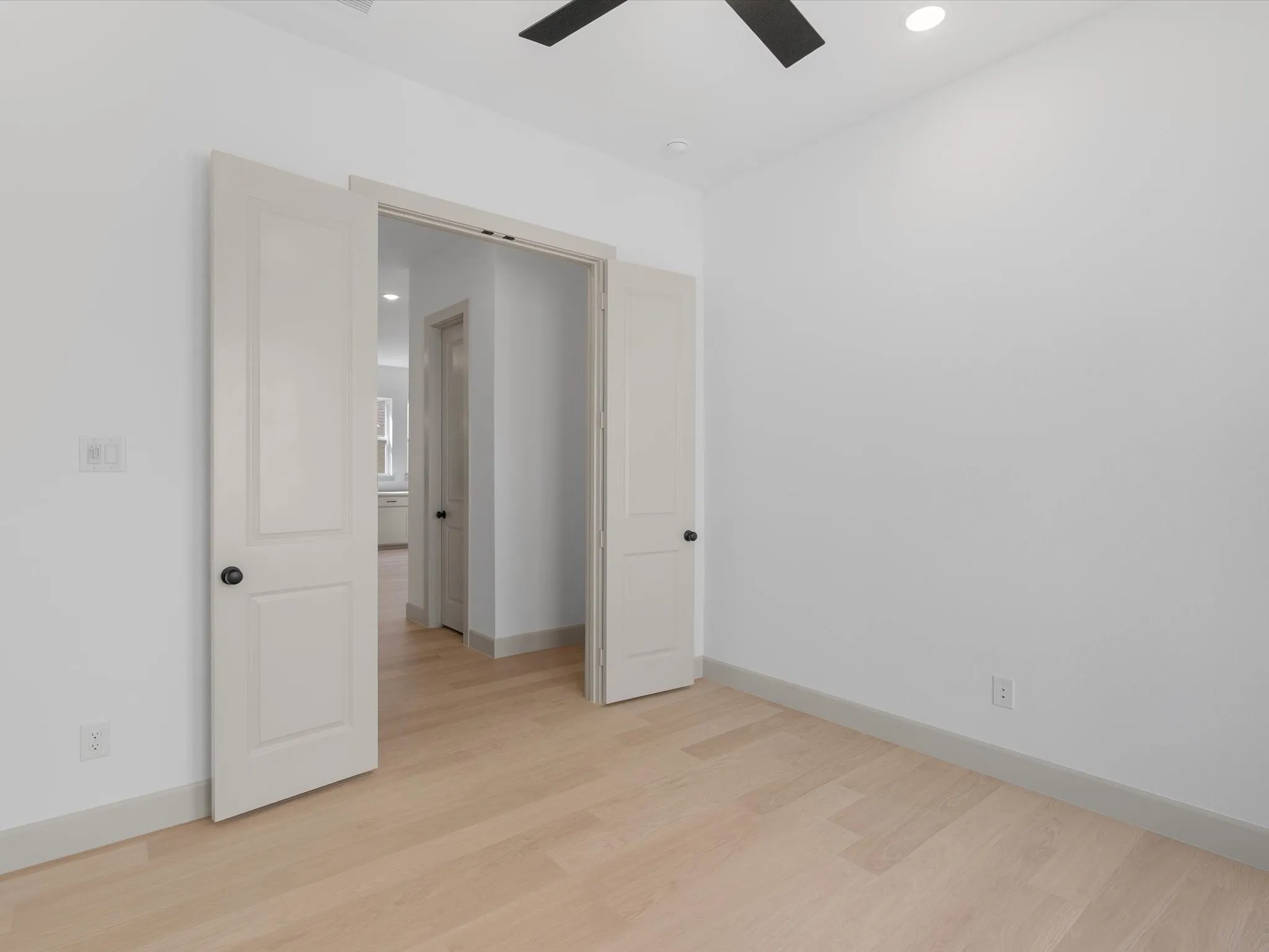 Separate Downstairs Study featuring Light wood-finish flooring, recessed lighting, and a ceiling fan