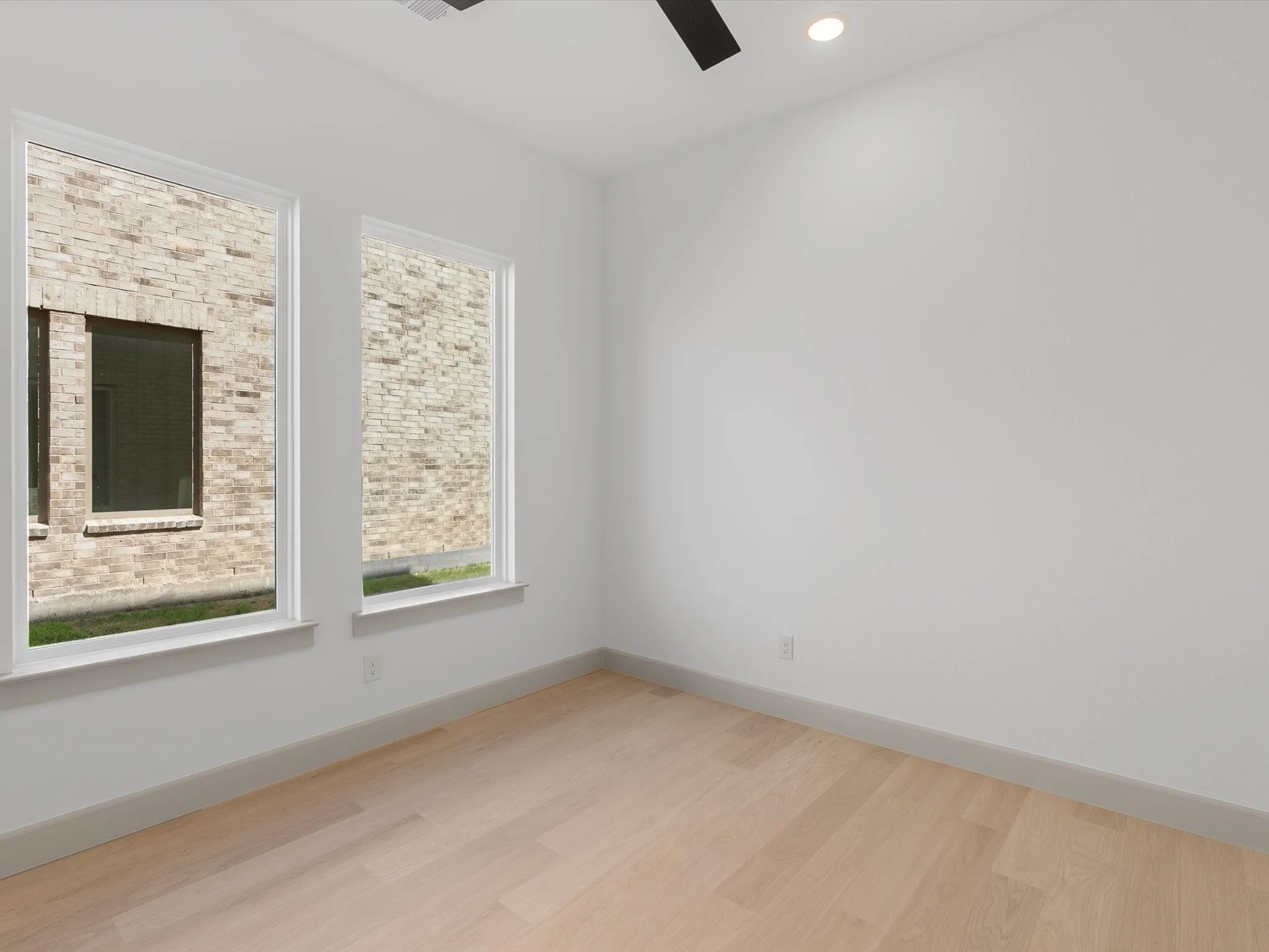 Separate Downstairs Study featuring Light wood-finish flooring, recessed lighting, and a ceiling fan