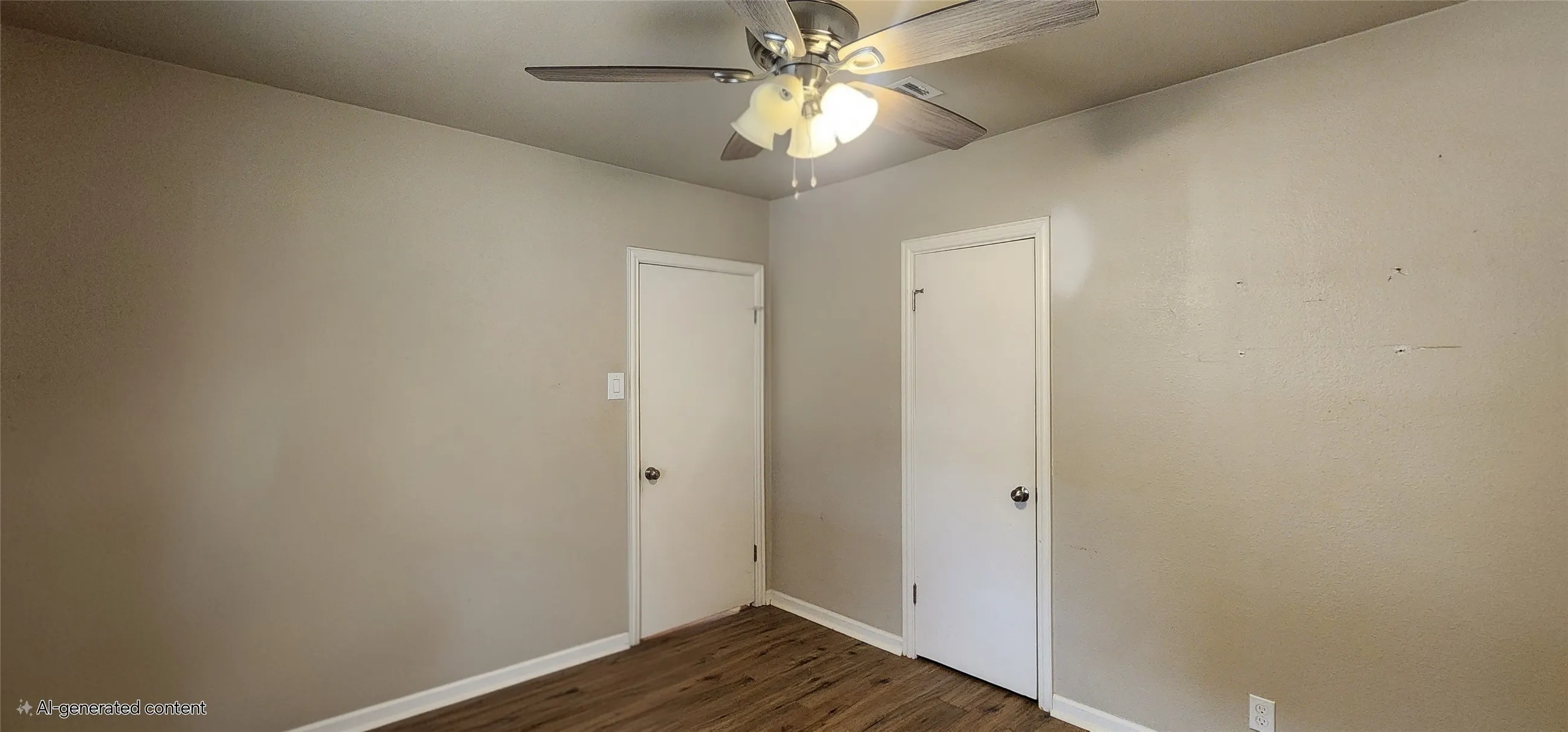 Bedroom2 neutral wall tones, two paneled doors, and ceiling fan with integrated lighting