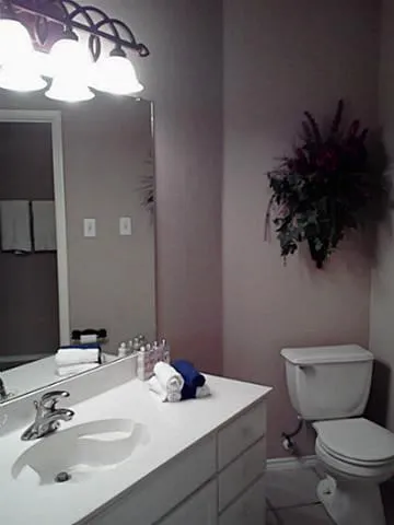 Bathroom vanity with an integrated sink, polished chrome faucet, and white cabinetry