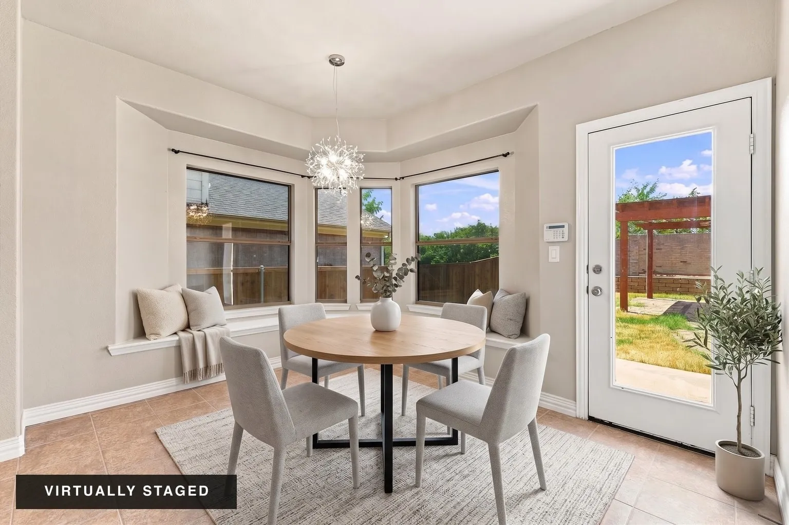 Bay window with built-in bench seating, contemporary pendant lighting, tiled flooring, and a glass-paneled exterior door