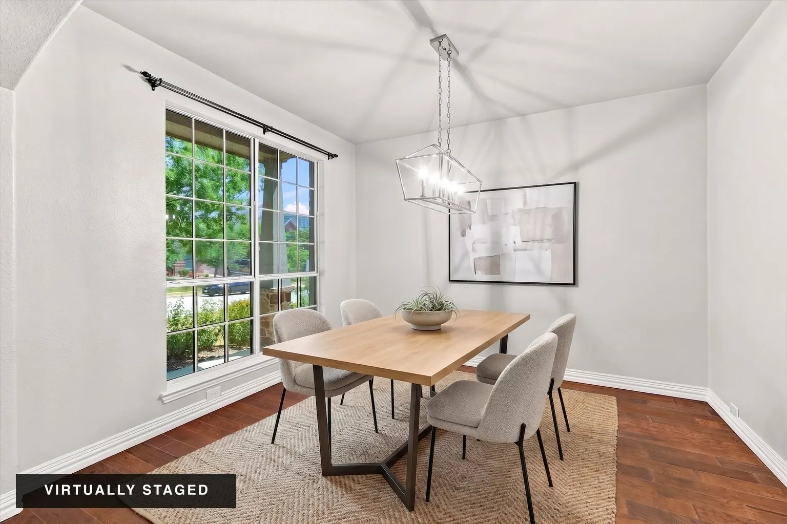 Hardwood flooring with a contemporary chandelier, white walls, and a large multi-pane window