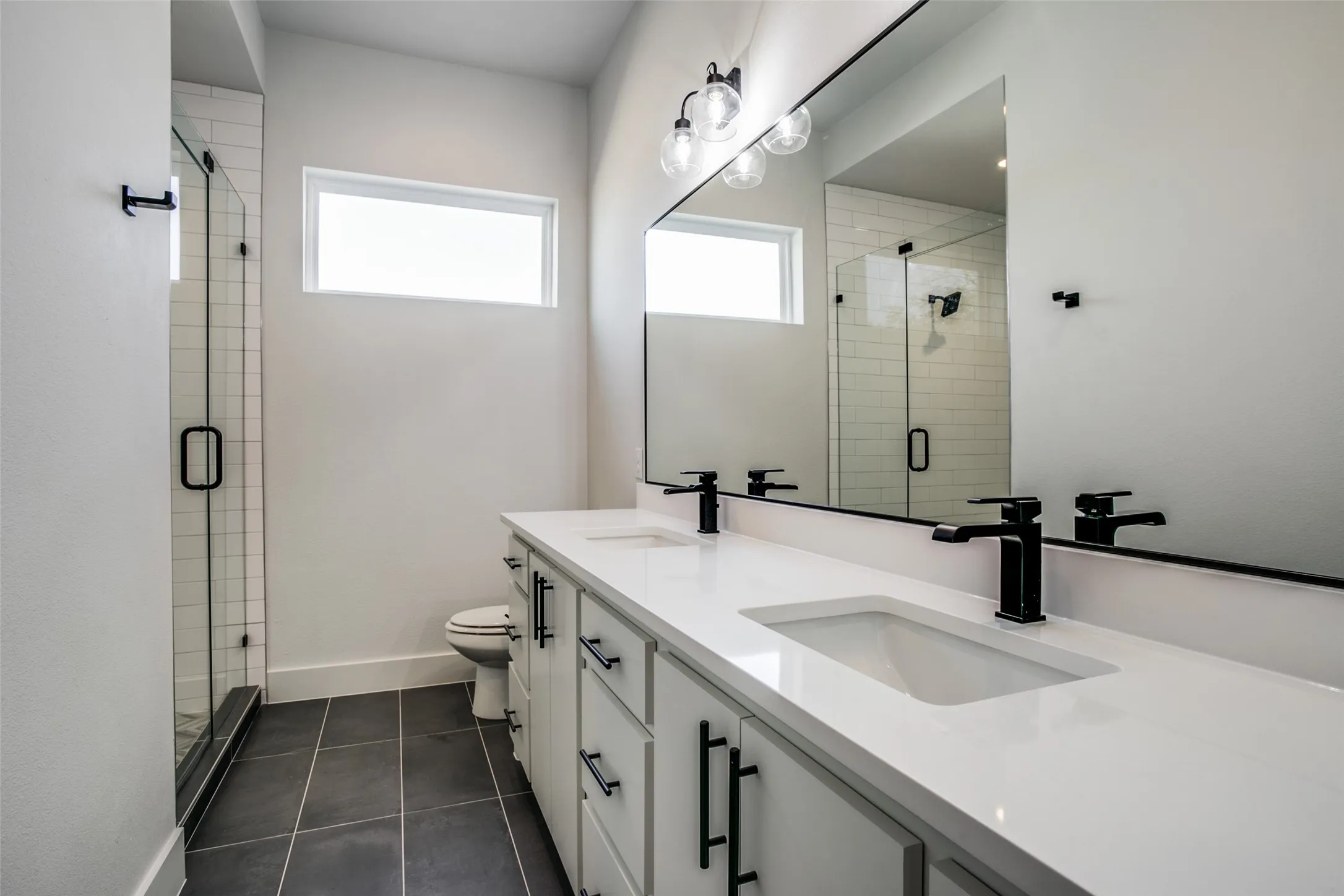 t the top of the stairs is this wonderful secondary bath with full shower, large vanity with dual sinks and designer fixtures.